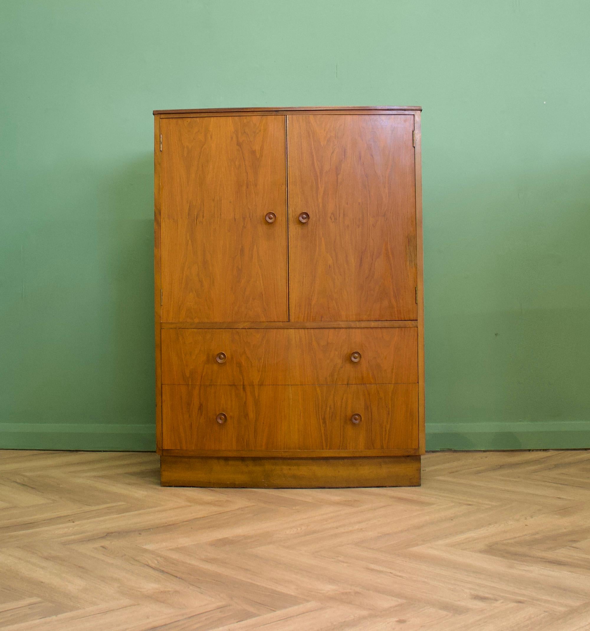 A vintage walnut Art Deco style tallboy or linen cabinet
Inside the top compartment, there are two shelves - the top is a more recent addition and is made out of plywood
There are two drawers to the bottom and it also features solid wood