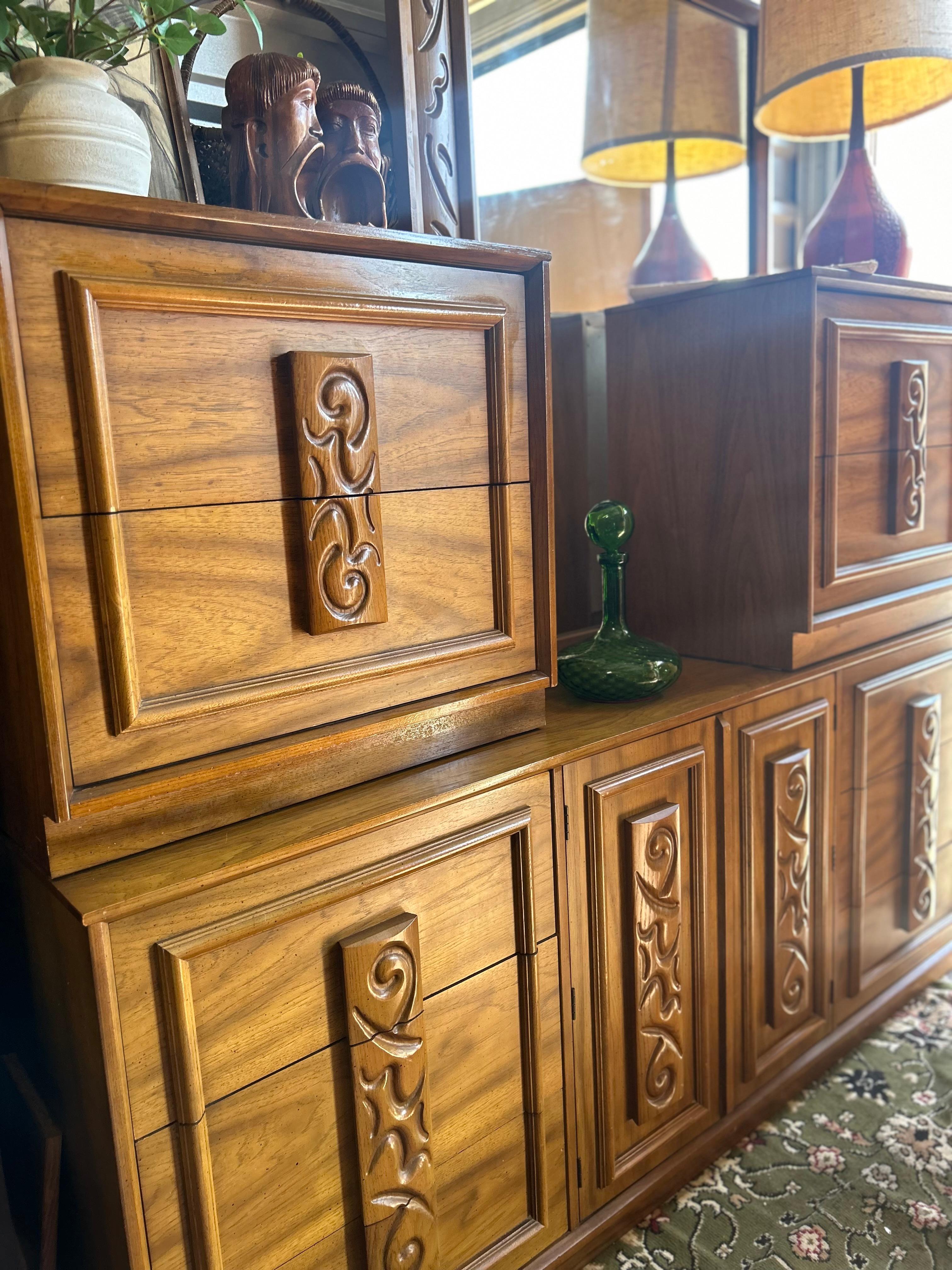 Gorgeous 5 piece solid wood bedroom set. Smooth sliding drawers. Stunning wood grain pattern. Mid century modern design and appeal. The carving on the handles of the dresser are such a nice touch. 

-2 nightstands - W 26” D 16” H 24”
-Long dresser -
