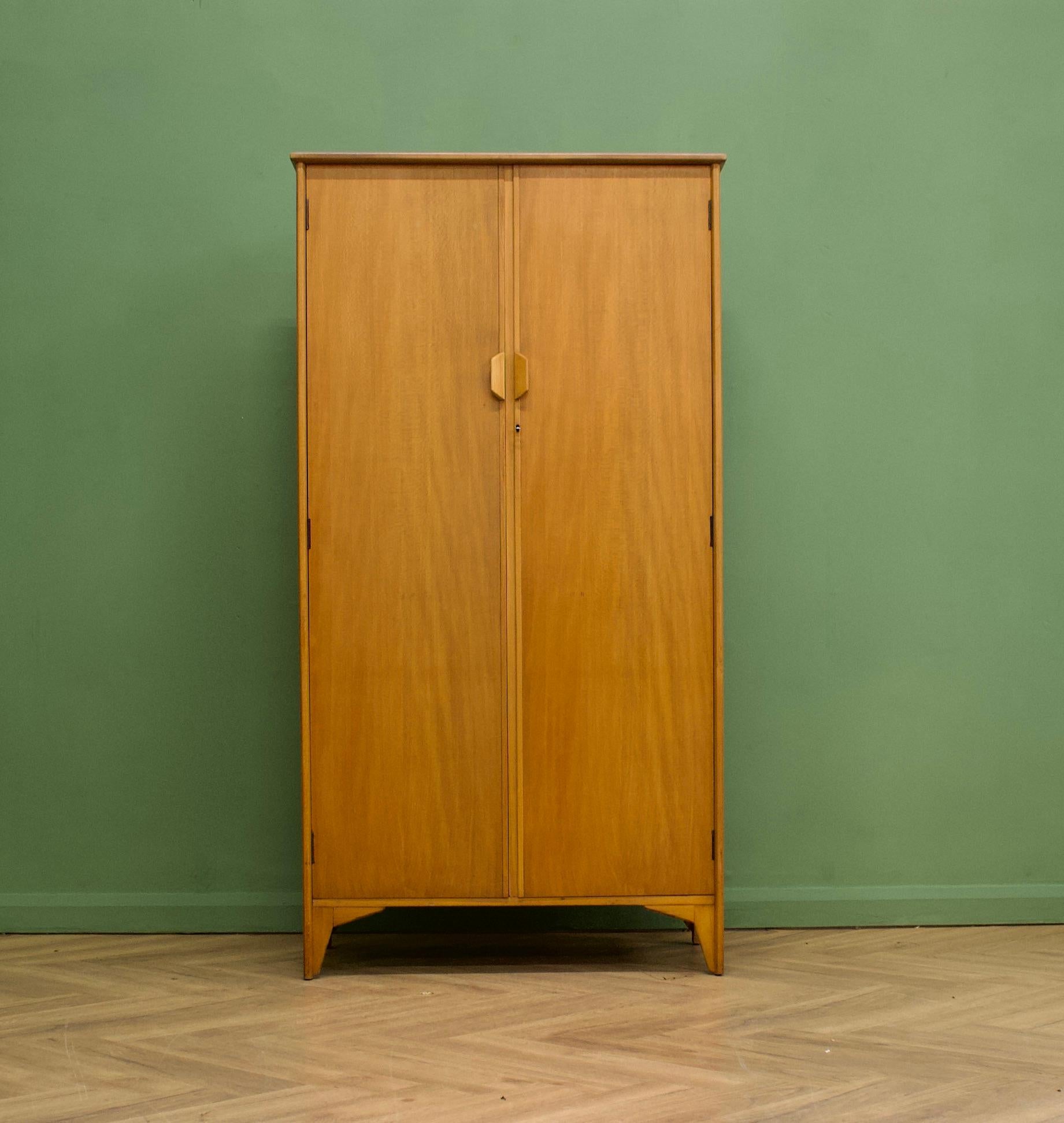 A rare vintage beech wardrobe, designed by Christopher Heal for Heals furniture store - 1951


A minimalist and modernist design - heavily influenced by the Scandinavian style of the time
Featuring a rail the full width and an internal full length
