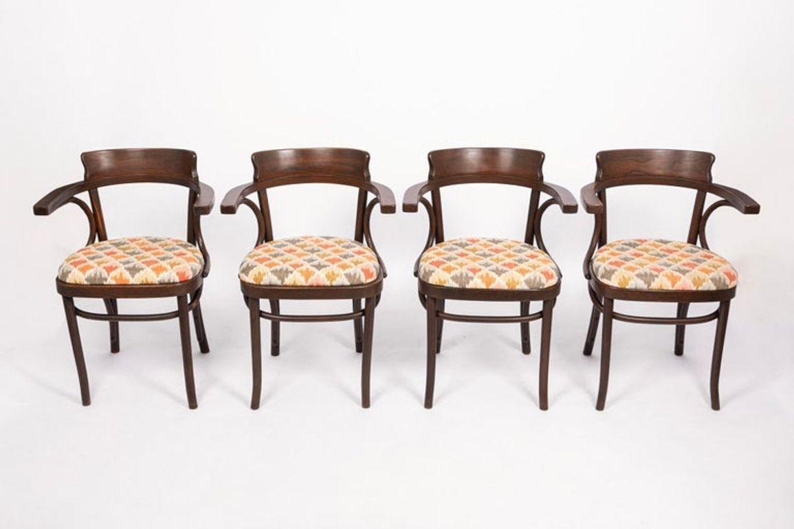 This set of four Vienna Secessionist (Jugendstil) style beech bentwood cafe armchairs are in the style of Jacob & Josef Kohn and Mundus (Austrian) designed in the early 20th century. These classic bistro chairs have a simple design with elegant
