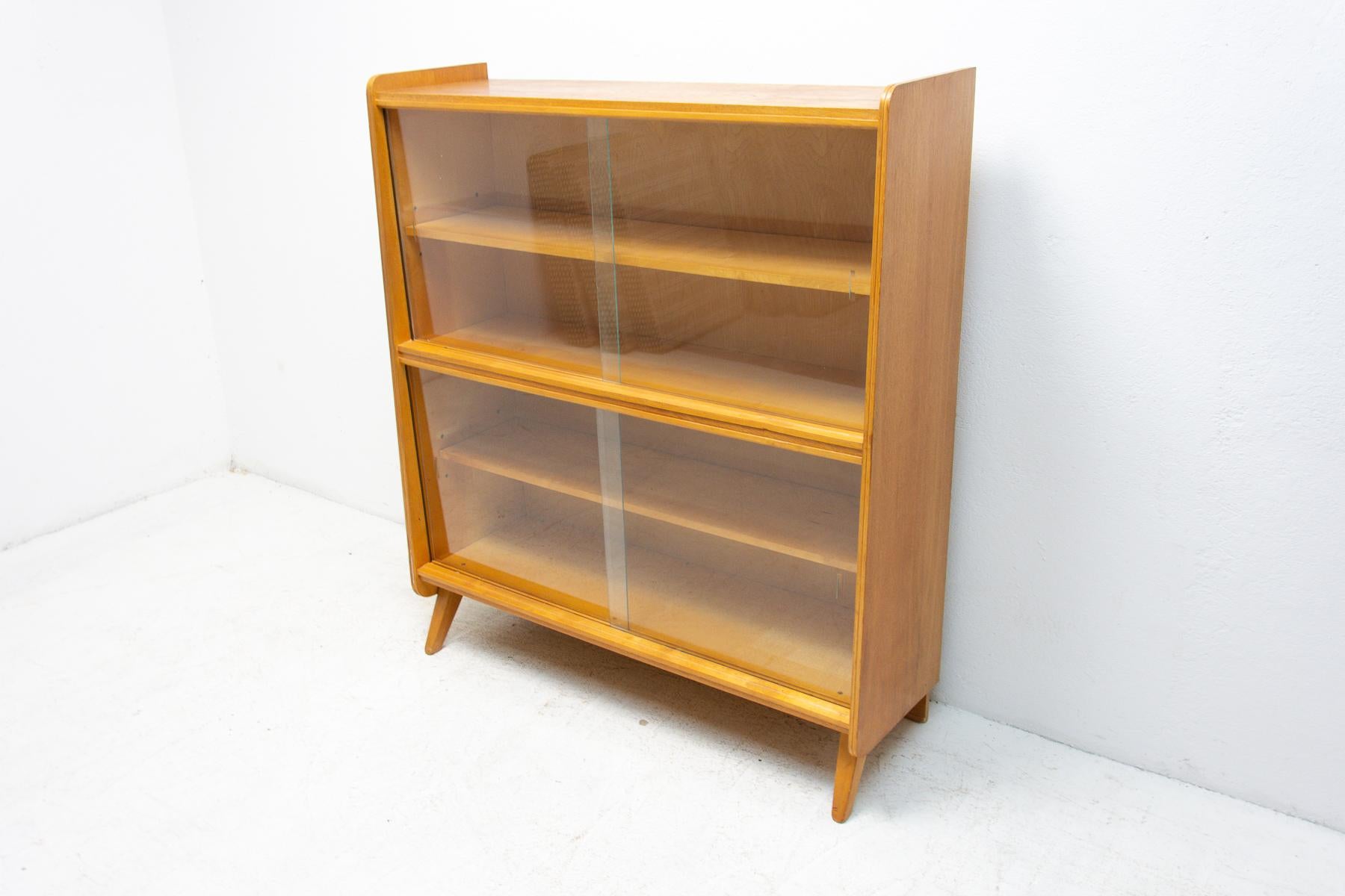 Mid century vintage bookcase from the 1960’s. It was designed by František Jirák and was manufactured by Nový Domov company in the former Czechoslovakia. Features a simple design, a glazed section with five storage spaces. In good Vintage condition,