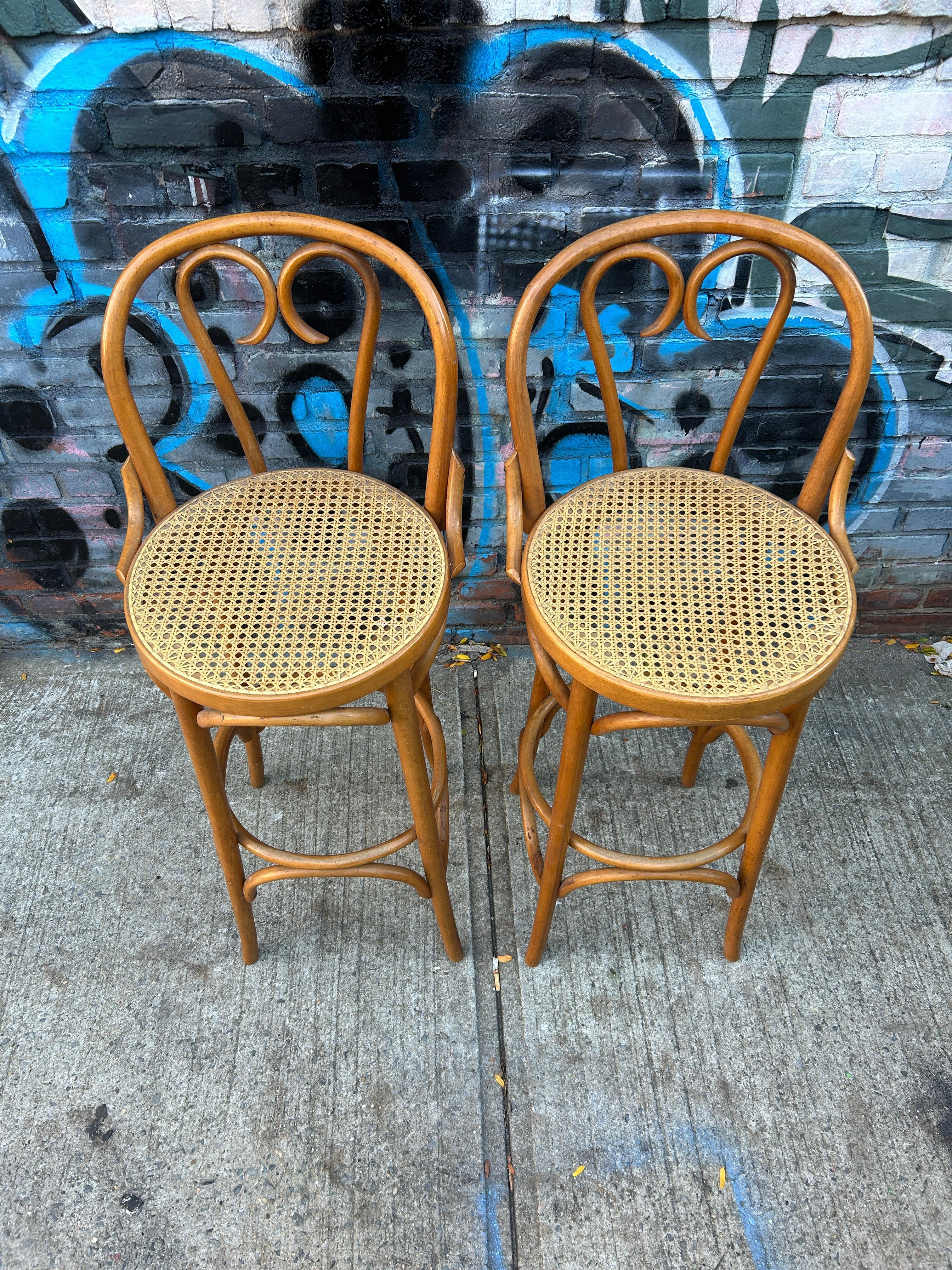 Mid century cane round bar height stools by Thonet blonde bentwood with light cane. Seat height is 30” high. Great vintage condition. Cane is perfect on both stools. Very sturdy and ready for use. Located in Brooklyn NYC

Sold as 2 stools (1)