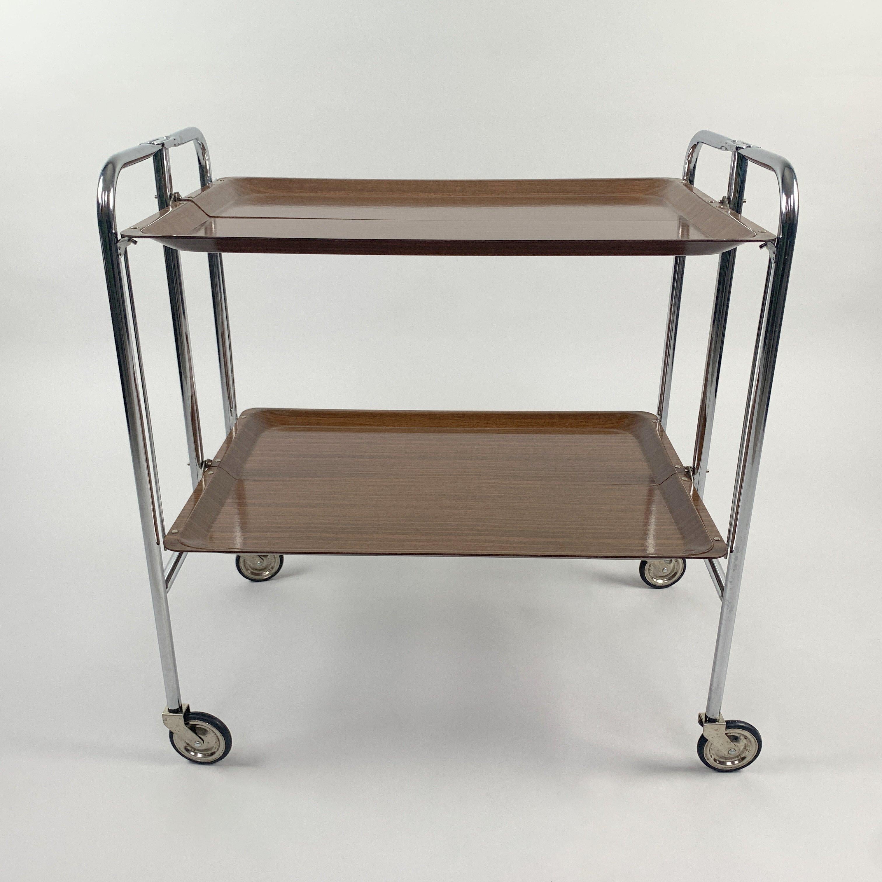 Mid-Century Modern, vintage serving tea cart consisting of laminated wood and chrome. Produced in Germany in the 1950s. Very good vintage condition.
