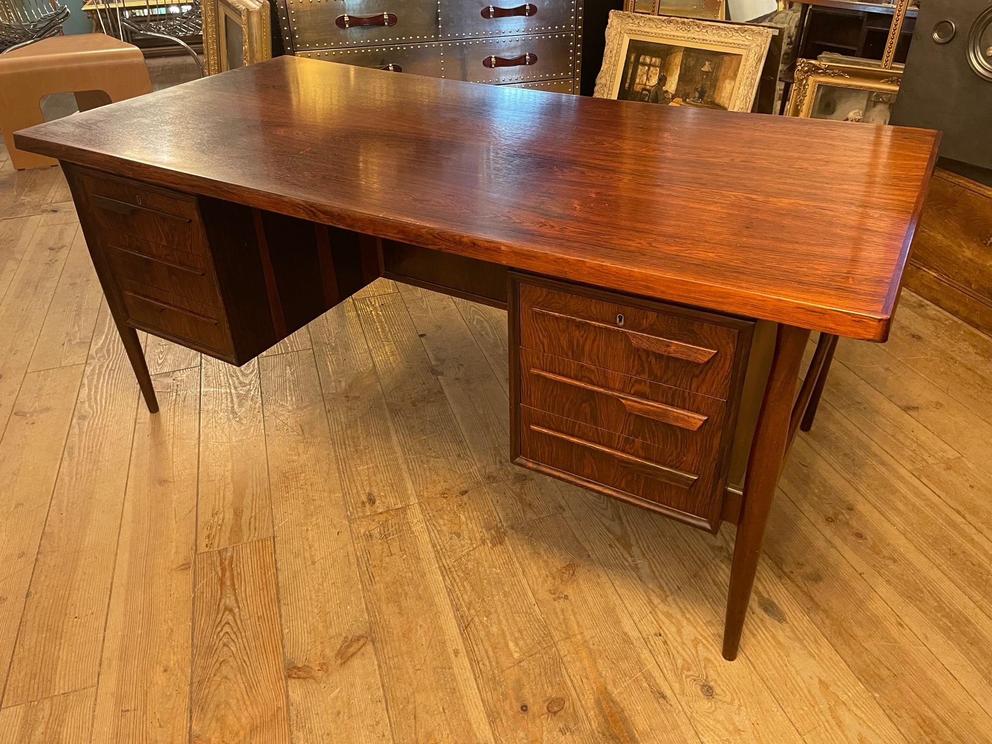 Beautiful mid century vintage Scandinavinan rosewood desk by the danish designer Arne Vodder. 
This desk is double sided, six drawers (two can be closed with keys) on one side and two opening doors on the other side. 
Excellent quality and typical