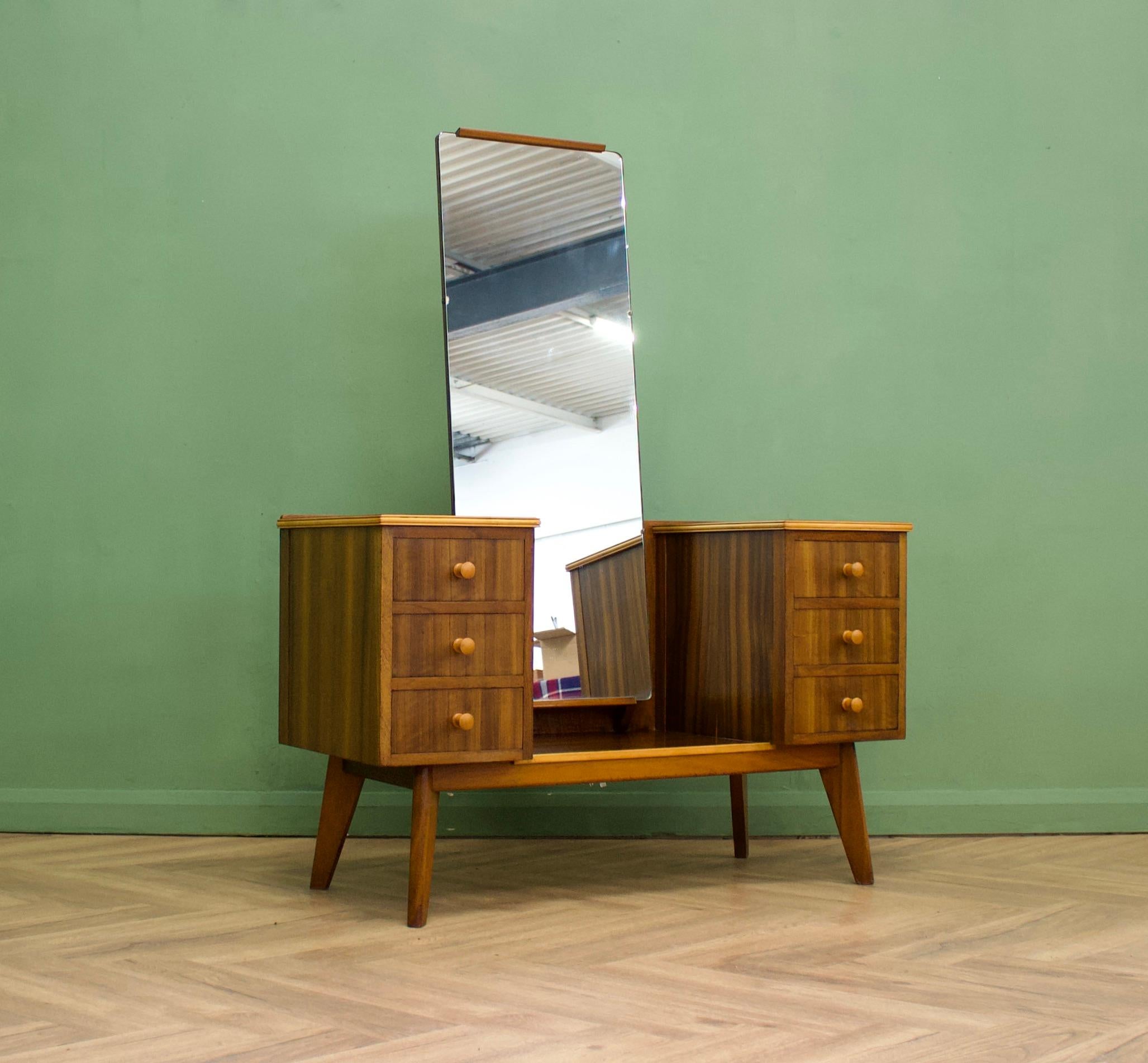 A beautiful quality walnut  dressing table by Morris of Glasgow
Featuring six drawers