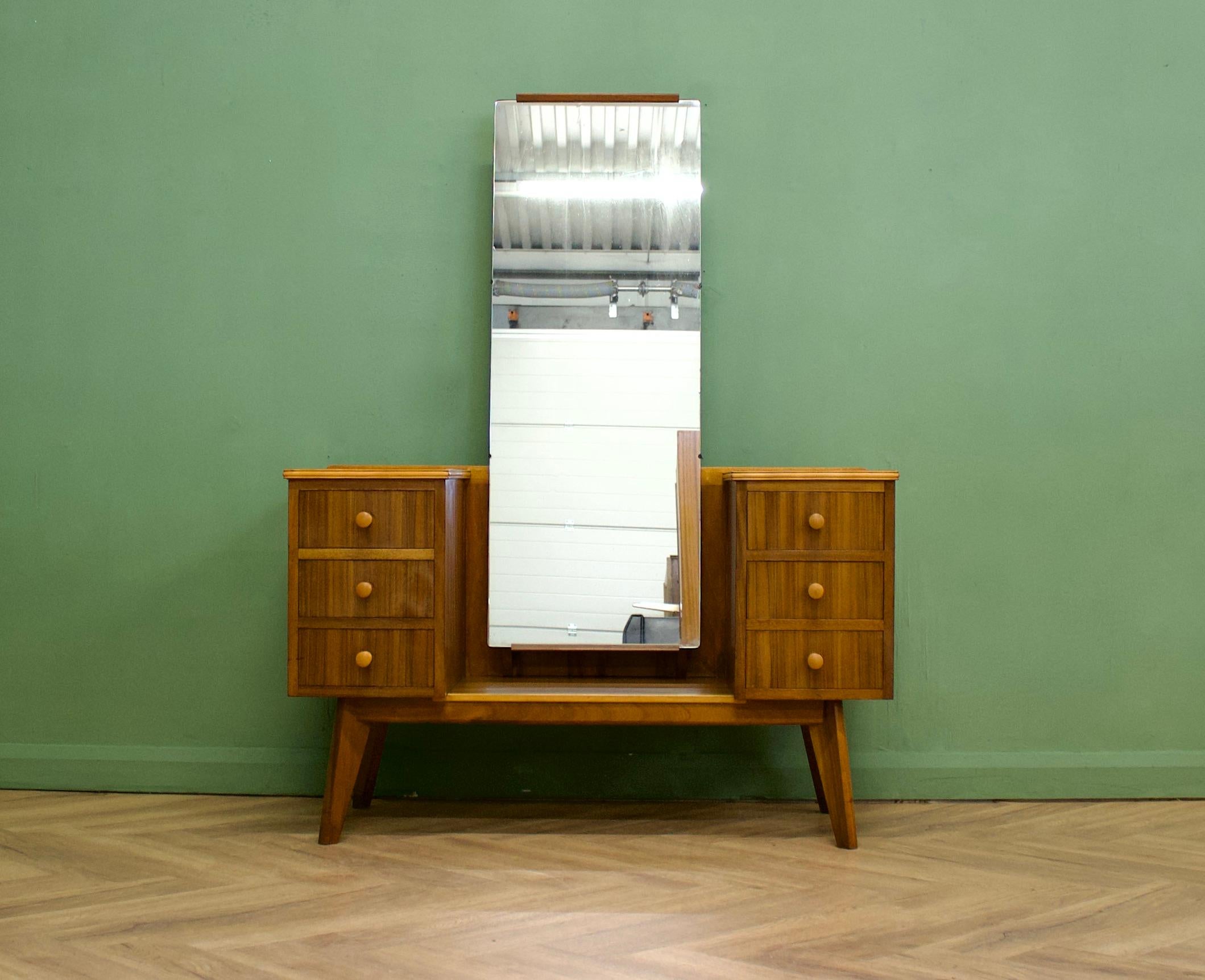 A beautiful quality walnut  dressing table by Morris of Glasgow
Featuring six drawers