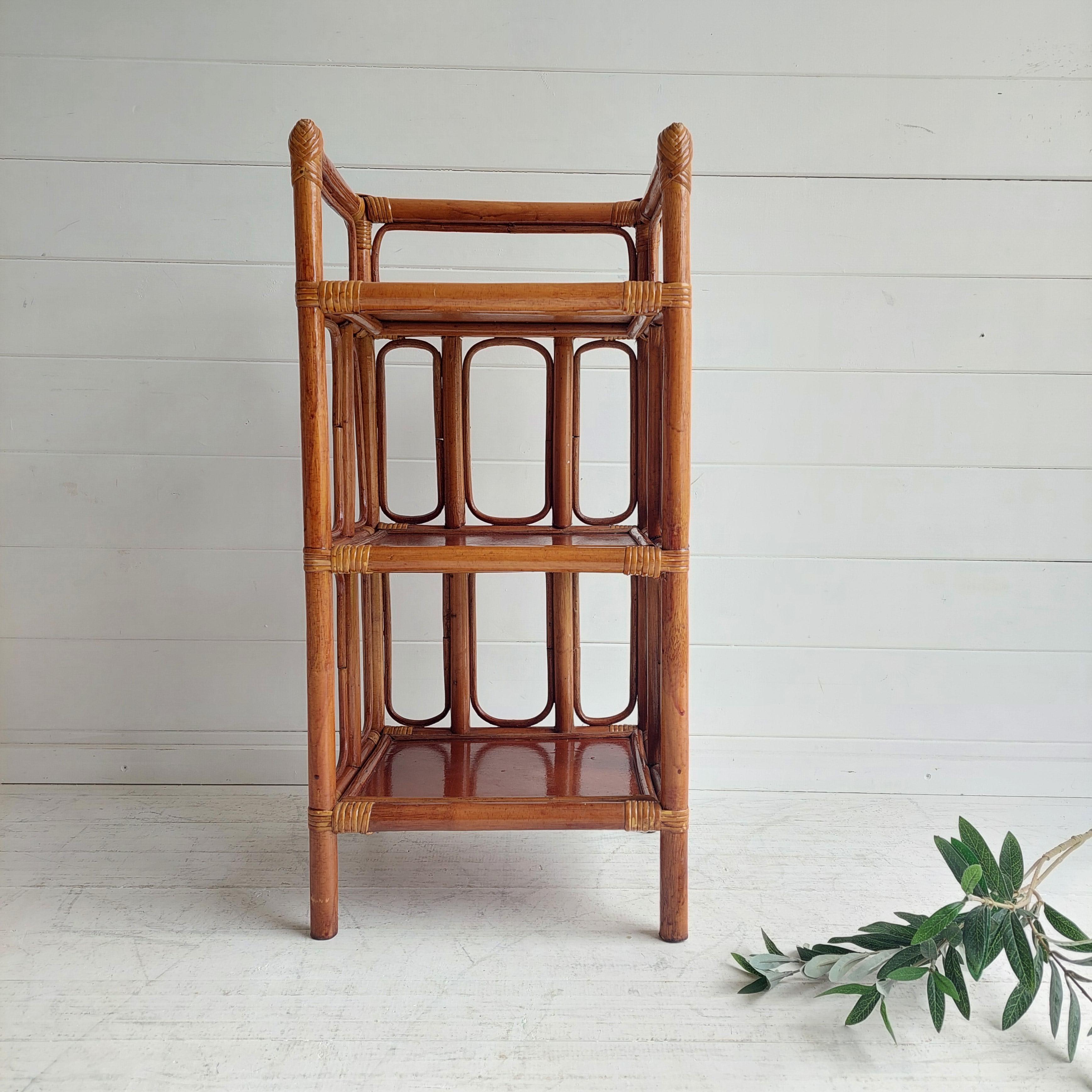 Vintage small bamboo wicker cane canework wooden. 
Three Tier Standing Shelf Shelving Unit Display Plinth Wall stand circa1960s

French vintage bamboo display stand with three shelves. Solid framework, heavy with decorative cane ovals at the