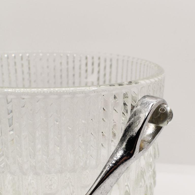 A beautiful thick glass ice bucket with a silver metal handle. The sides of this bucket have a lovely raised droplet texture. This will be a gorgeous addition to any bar. 

Dimensions:
5
