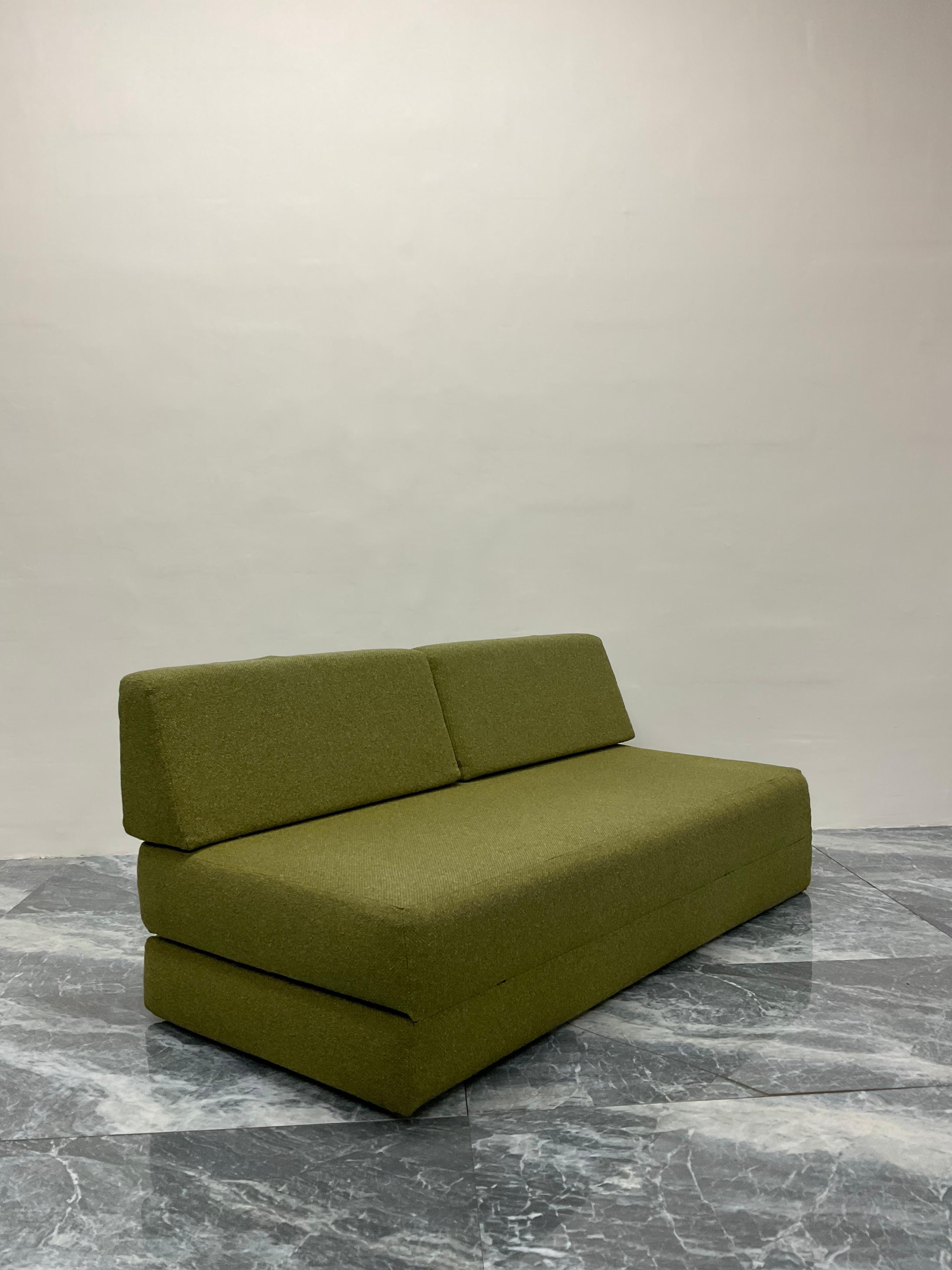 Mid-century vintage green fabric sofa that folds out into a bed, 1970s. Tubular metal frame and backrest for support.

Bed Dimensions:
W 61