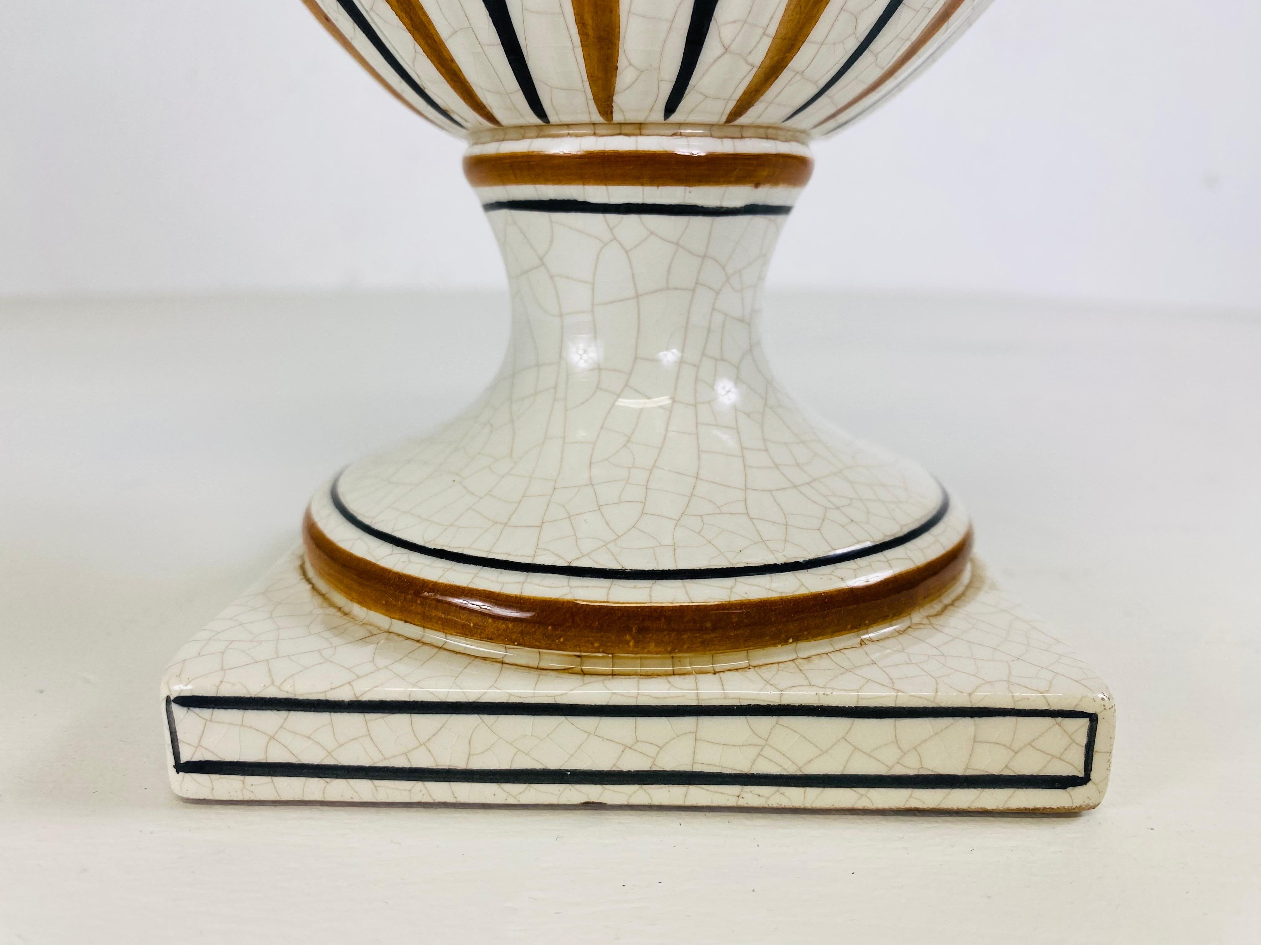 This is a mid century vintage hand painted pottery urn with lid. This hand painted classical Italian urn has beautiful tones of chocolate brown, Amber and cream. This urn with lid was made in Italy or 1950.