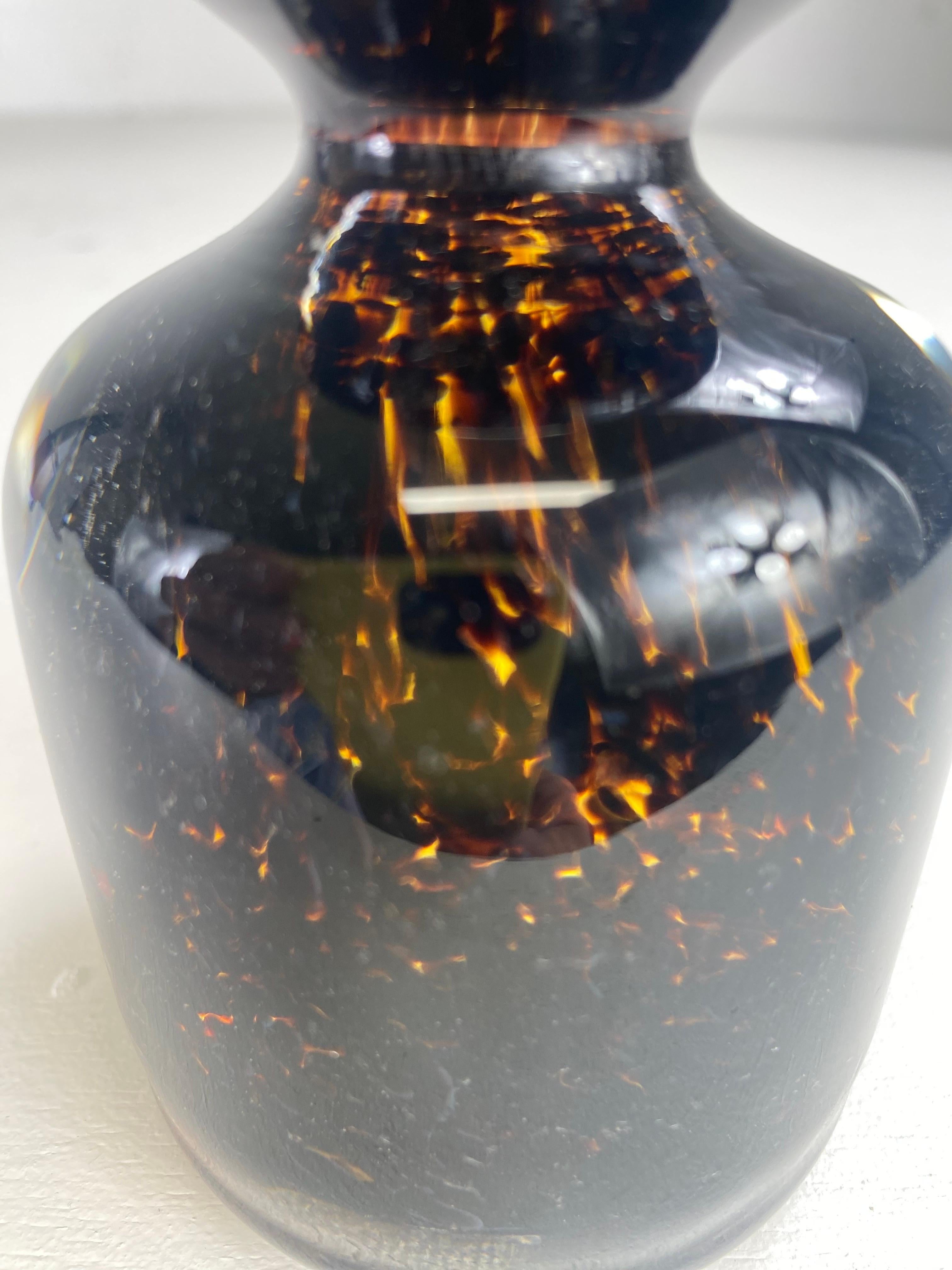 This is a mid century vintage handblown glass Murano paperweight. This paperweight has a unique design in that the interior of the glass looks like tortoiseshell with beautiful tones of dark brown, Amber and gold. This vintage paperweight has his