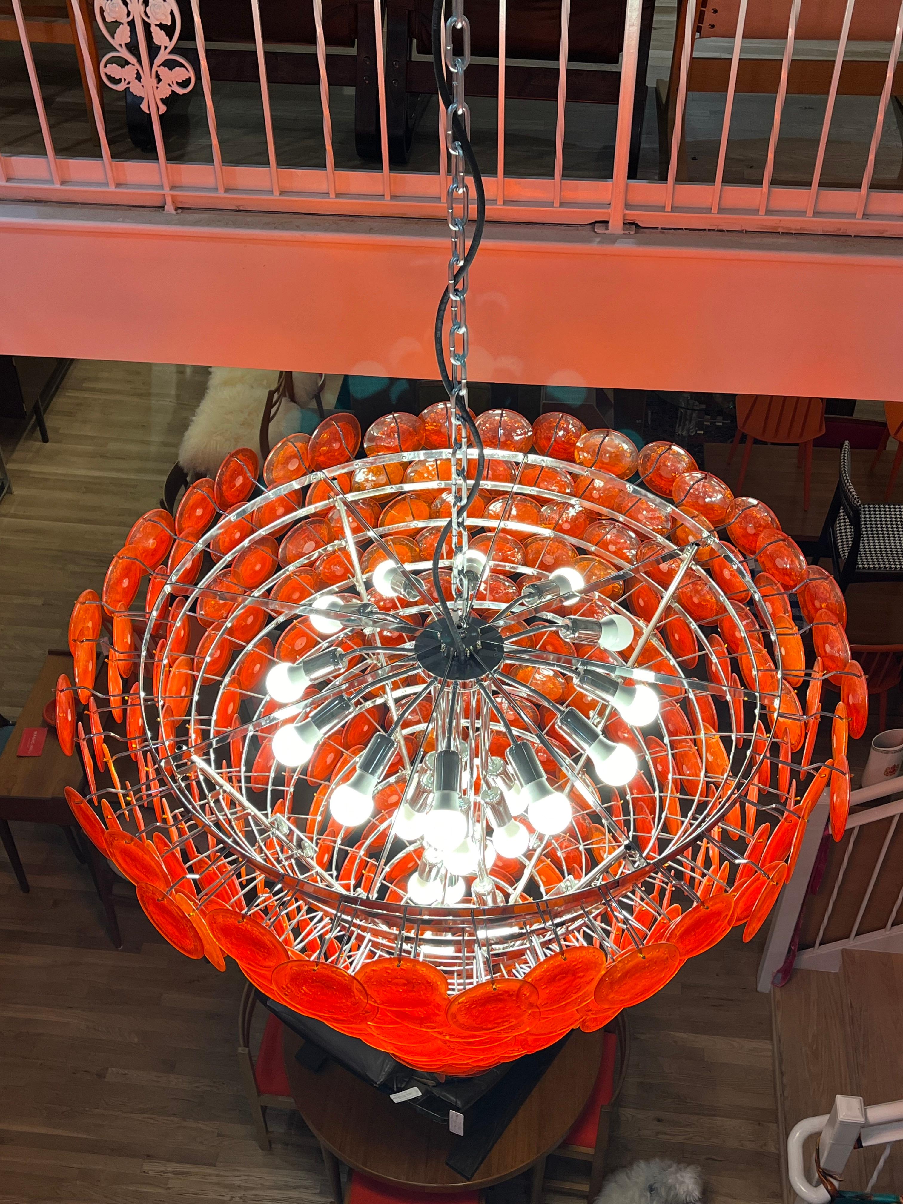 Stunning mid-century vintage Italian huge chandelier with about 300 discs. Each disk is about 4' inches handblown extremely heavy about 1000 pound with the glass.  Lightbulb. 17 tiers Excellent condition. 
55” top opening diameter 
Length 68” inches