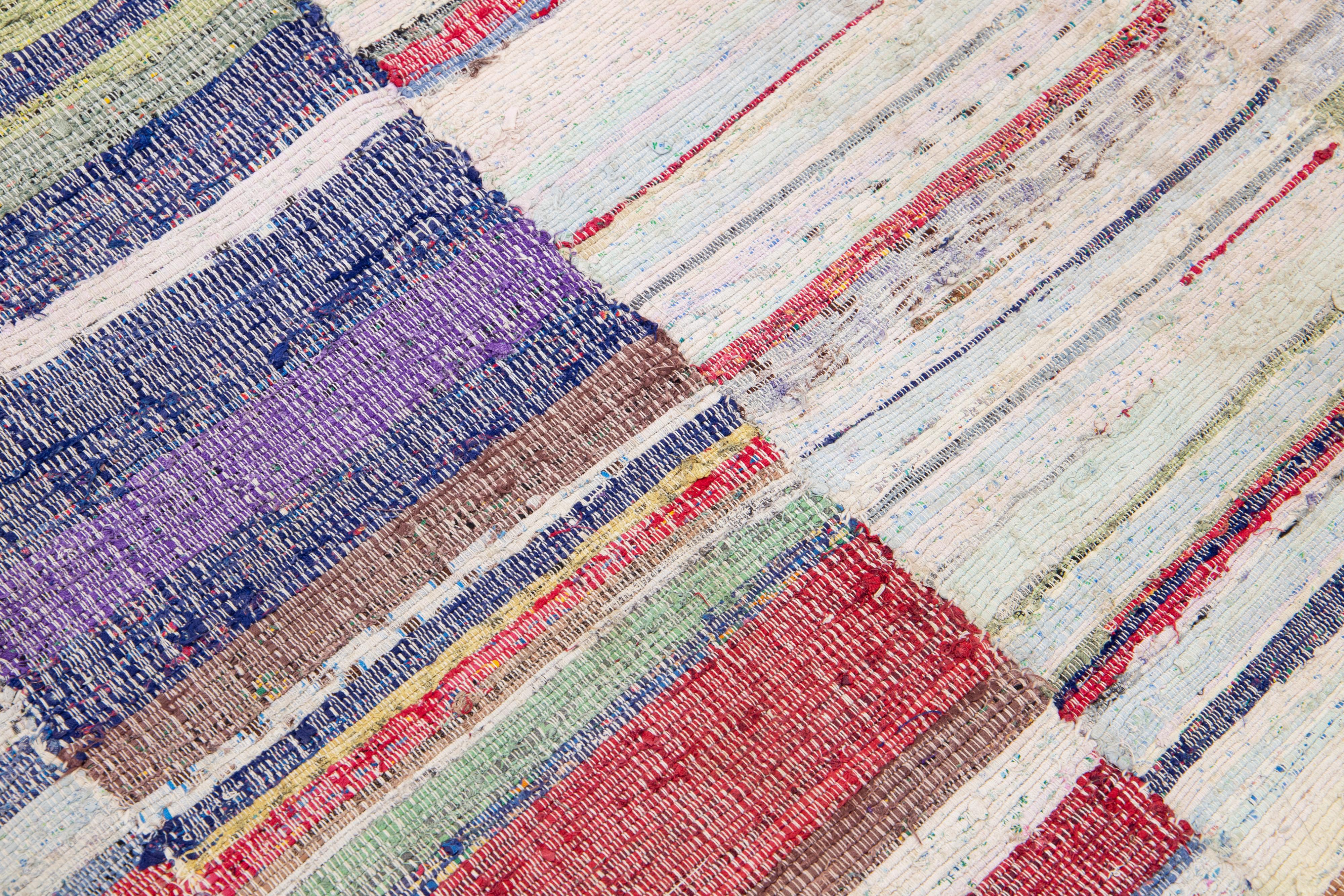Beautiful vintage Kilim flatweave wool rug with multicolor field features a gorgeous allover stripe motif. 

This rug measures: 4'10