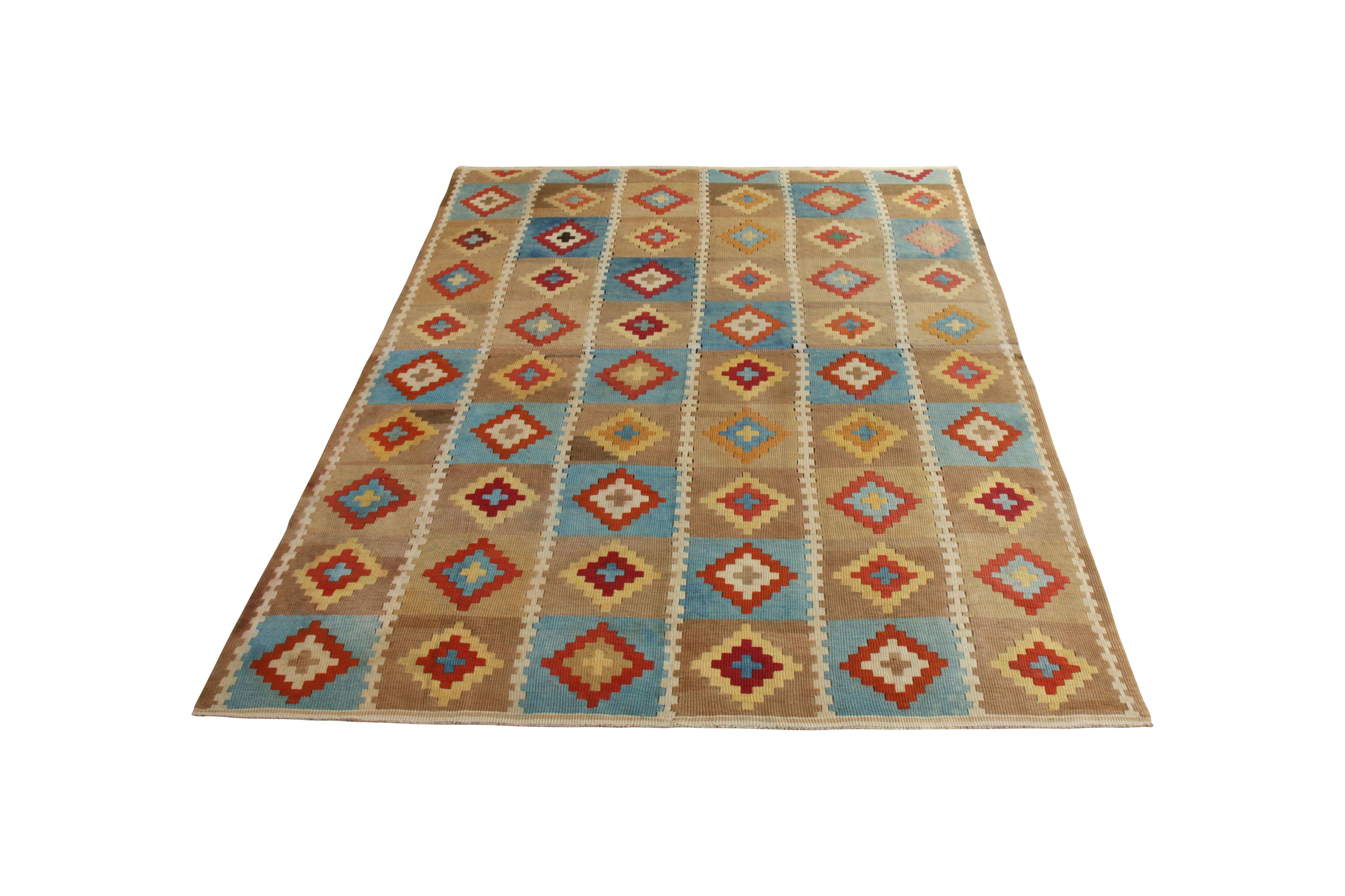 Handmade with flat-woven wool originating from Turkey circa 1950-1960, this vintage rug is a mid-century Kilim rug with a time-honored slit tapestry weave, connoting the dynamic nature of the diamond pattern and lending an arresting, collectible