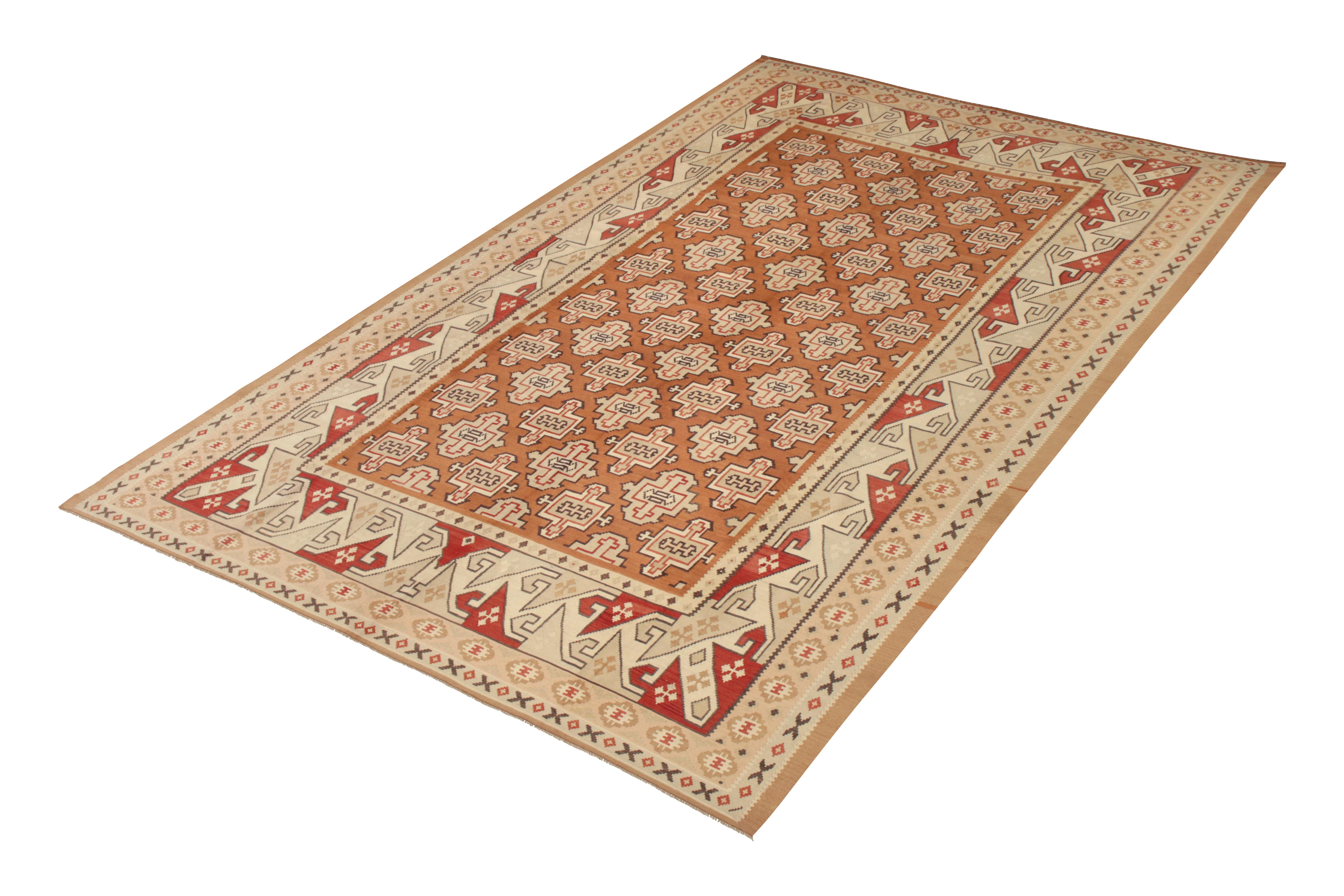 Handwoven in a wool flat-weave originating from Turkey circa 1950-1960, this vintage rug connotes a midcentury Kilim rug design of subtle rarity, drawing from classic traditional Kilim geometry to depict a very subdued Bessarabian Kilim sensibility