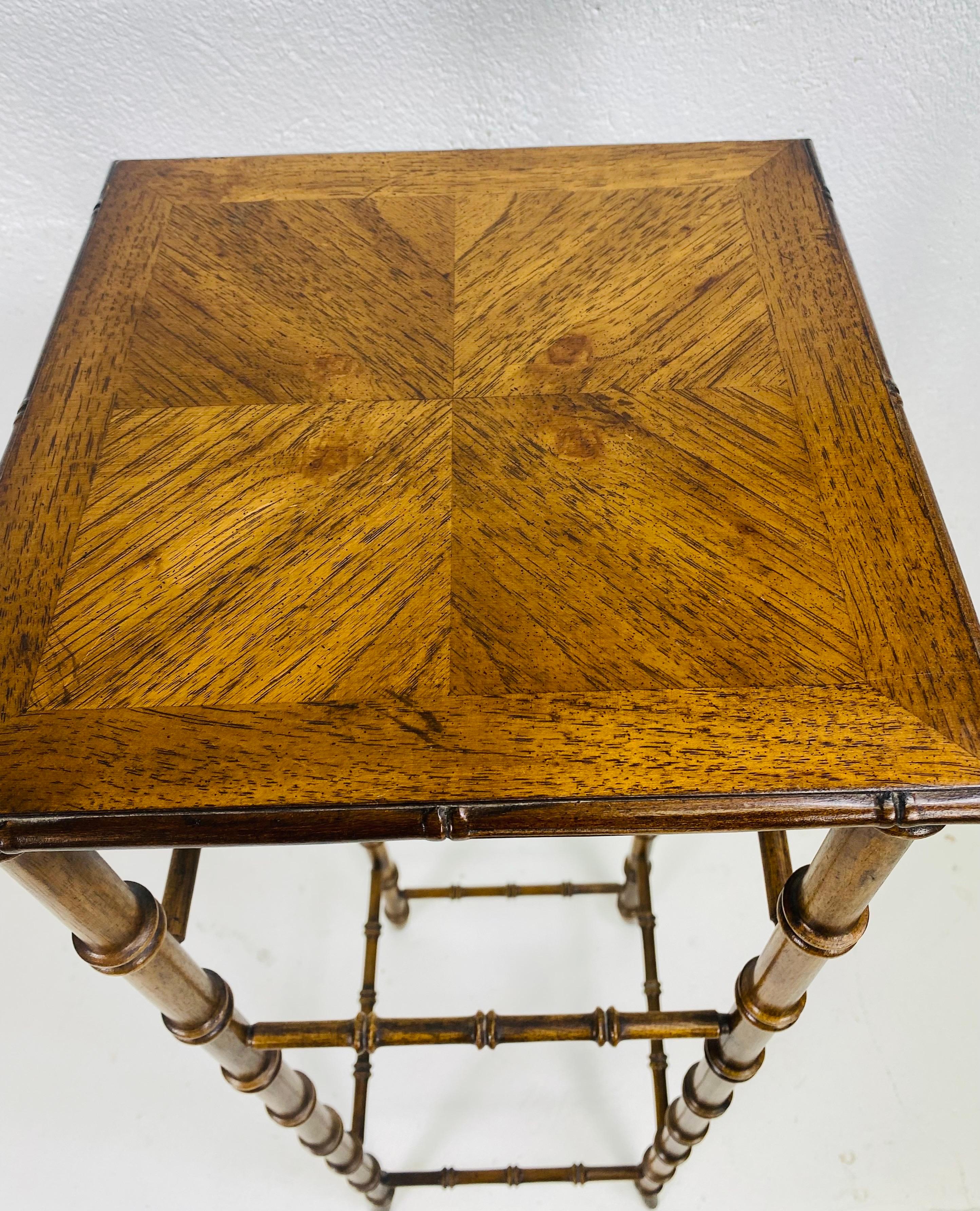 Se trata de una mesa con pedestal de bambú de imitación de la empresa de muebles Lane Furniture de mediados de siglo. Este pedestal es de estilo renacimiento de la Regencia, con una pata de imitación de bambú y una parte superior con incrustaciones