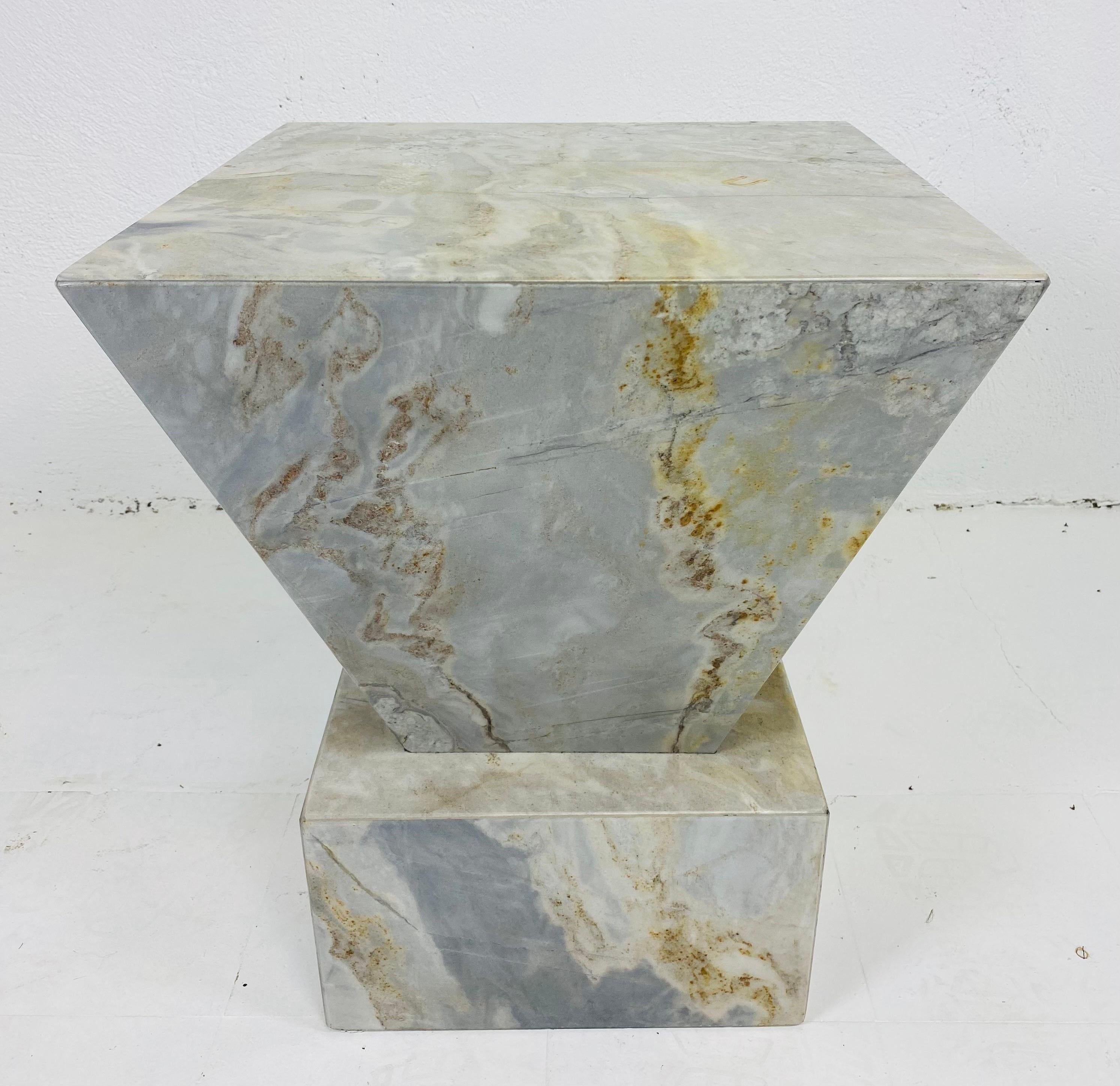 This is a midcentury vintage modern marble side table or pedestal. This Italian marble side table is made of a light gray marble with black, cream and tan vaining. This piece would work beautifully as a side table or a pedestal to display a