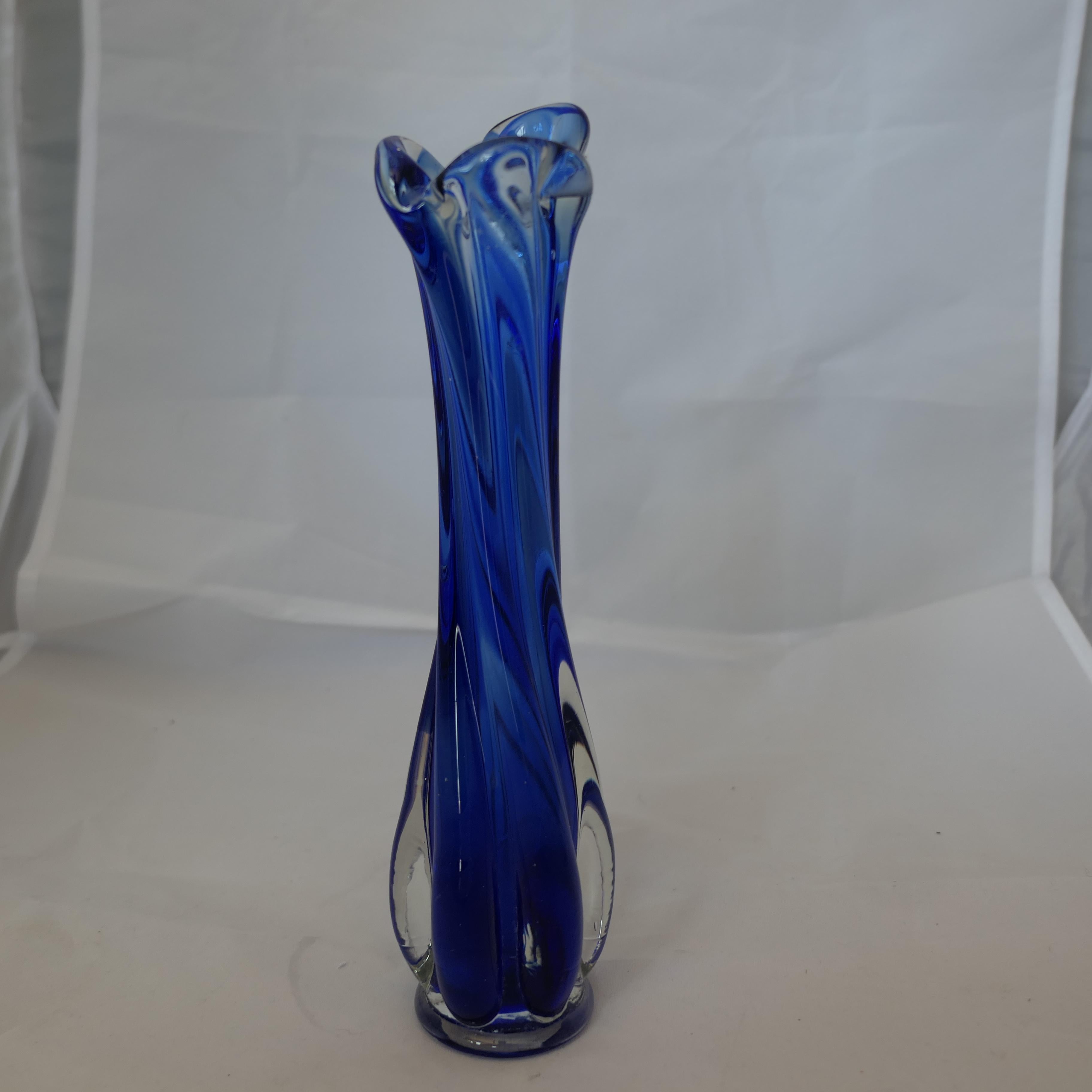 Mid Century Vintage Murano Cobalt Blue Vase

Mid Century Vintage Murano Vase in good condition, beautifully swung solid glass mixed with Cobalt blue elements
The Vase has no chis or cracks, it is 9” tall 2.5” in diameter 
FB211