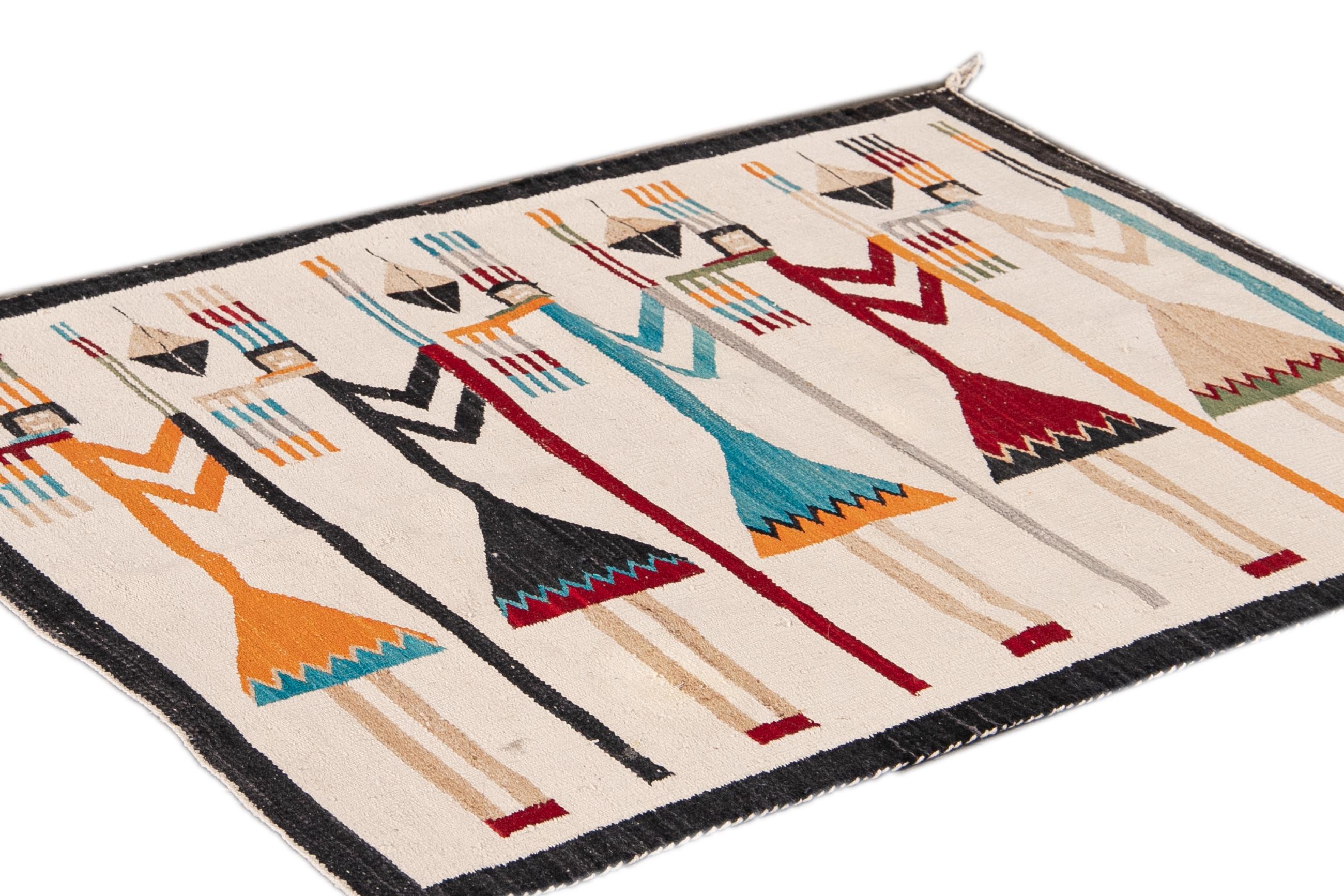 Beautiful Vintage Native American Yei Pictorial Blanket handmade wool rug with an Ivory field. This Pictorial rug has a black frame and multi-color accents in a gorgeous all-over geometric cultural design.

This rug measures 3'1