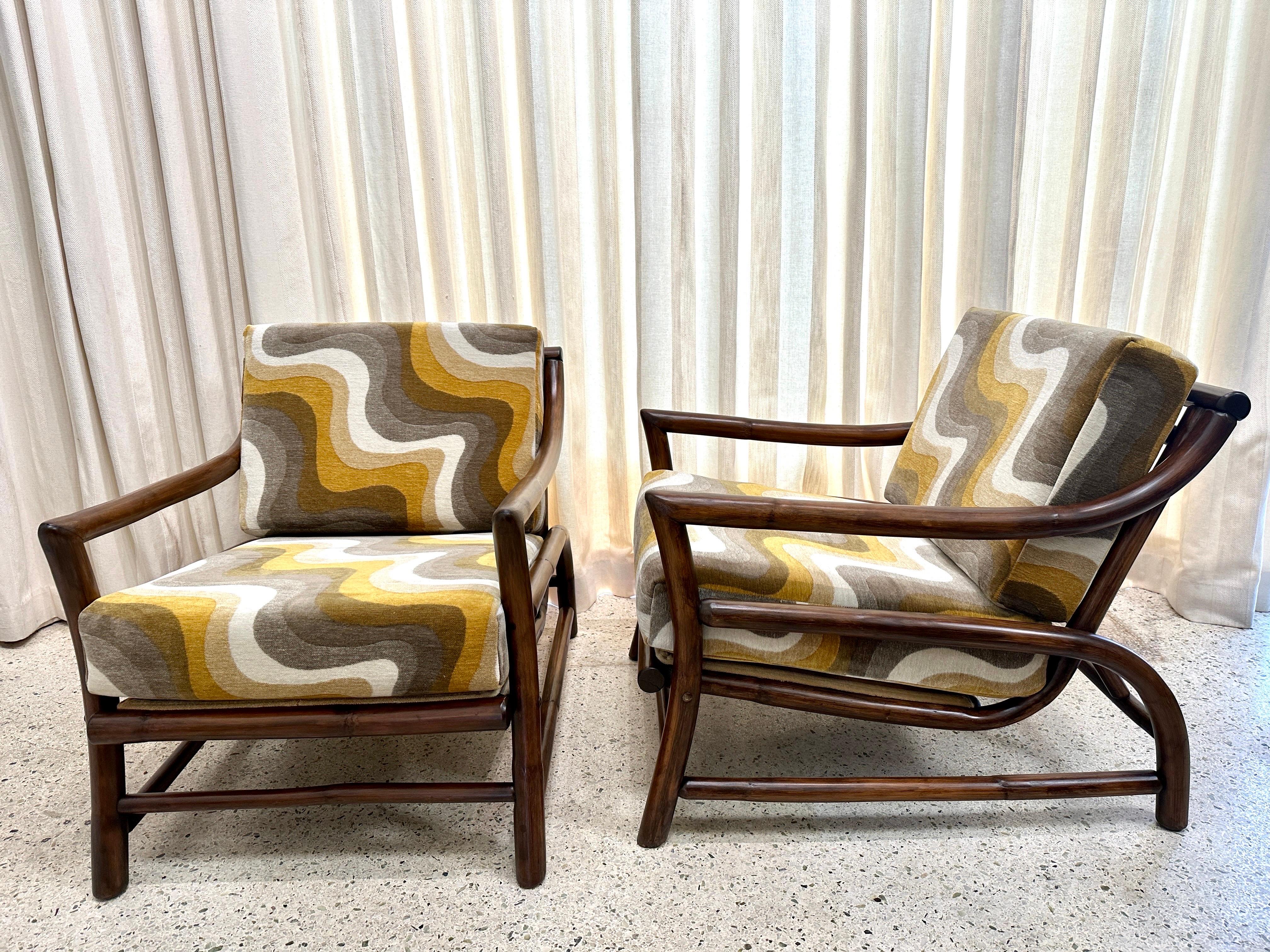 These wonderfully restored thick rattan framed lounge armchairs with a lovely new fabric to highlight their CHIC and vintage history.  Made in Italy in the manner of Bonacina and in wonderful, ready to use condition.  THIS ITEM IS LOCATED AND WILL