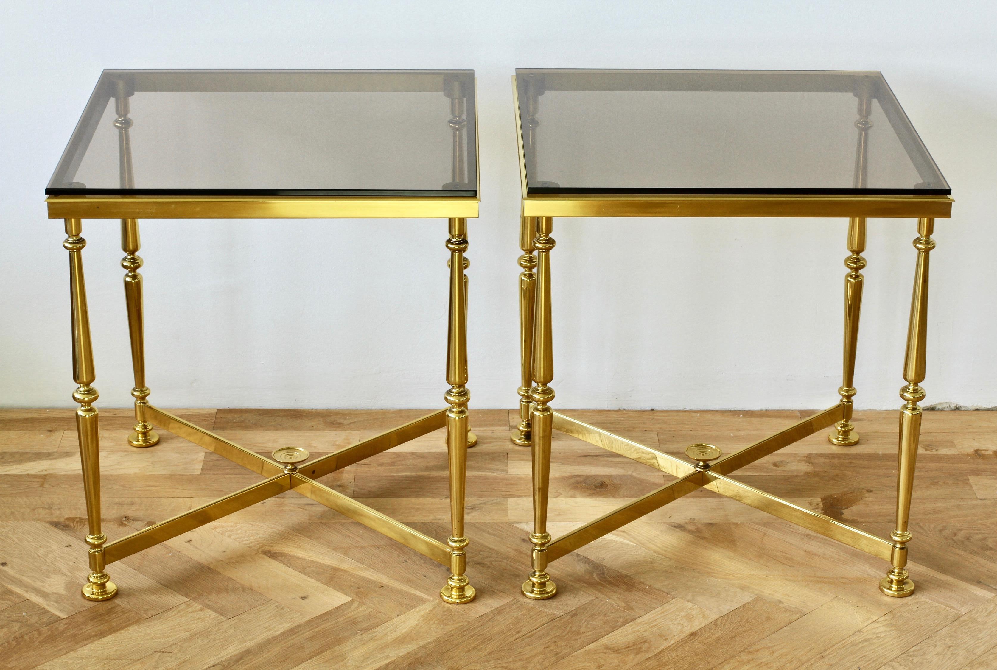 Wonderful pair of side or end tables (glass table tops not included) in the style of Maison Jansen, made by the Vereinigte Werkstätten circa 1970. Made from solid cast brass in the modern neoclassical style and crossed X-base. These delightful