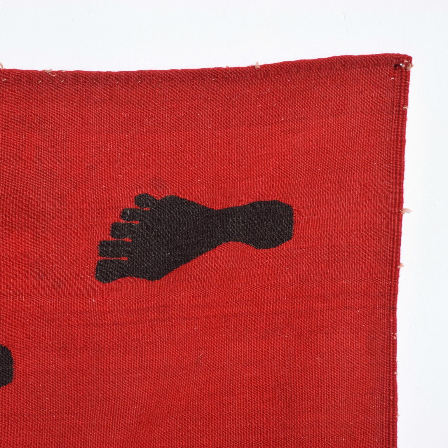 For your pleasure: Modern wall art tapestry in the style of Pedro Friedeberg and mid-century textile designer Cynthia Sargent.
A Black foot on red background in wool.
The  Dimensions: 76 1/2