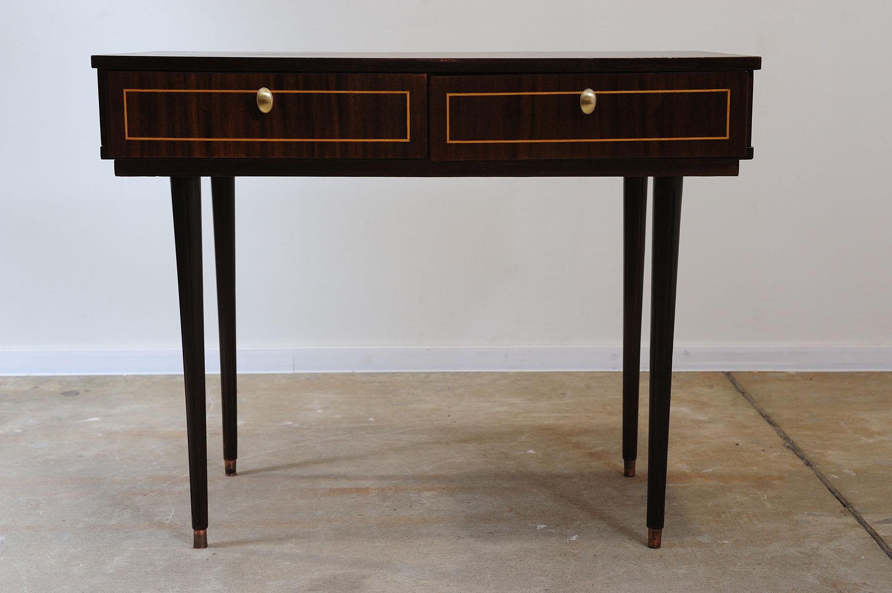 This mid century table was made in the former Soviet Union in the 1970´s as a part of a mahagony mid century modern living room.
Its design is elegant and modern. It can also be used as a dressing table.

It has interestingly shaped legs with arched