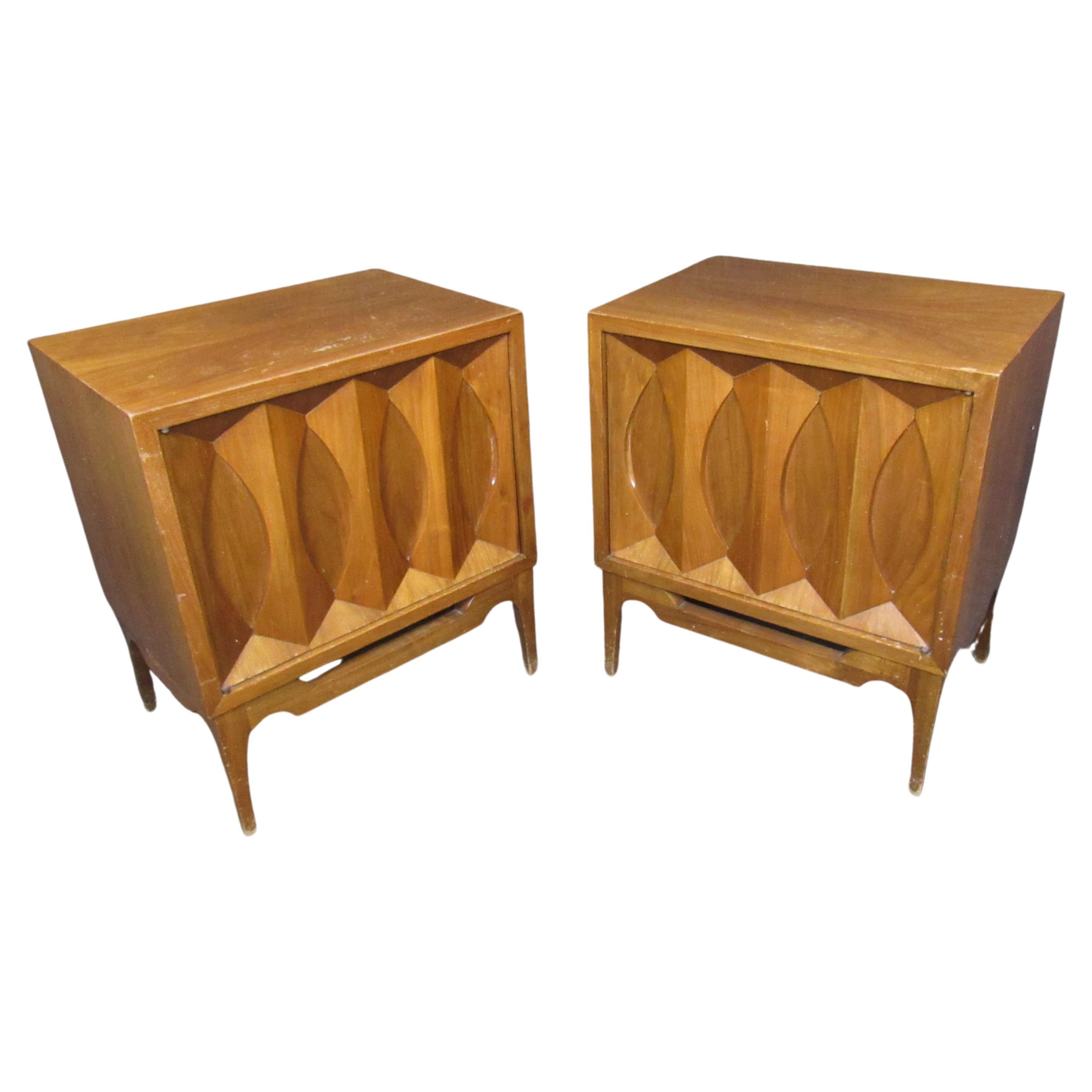 Endlessly interesting vintage Mid-Century Modern walnut night stands with fantastic sculpted details. Each door features a panel of carved bowties reminiscent of the Classic Broyhill Brasilia and Kent Coffey Perspecta lines of the 1950s and 1960s. A