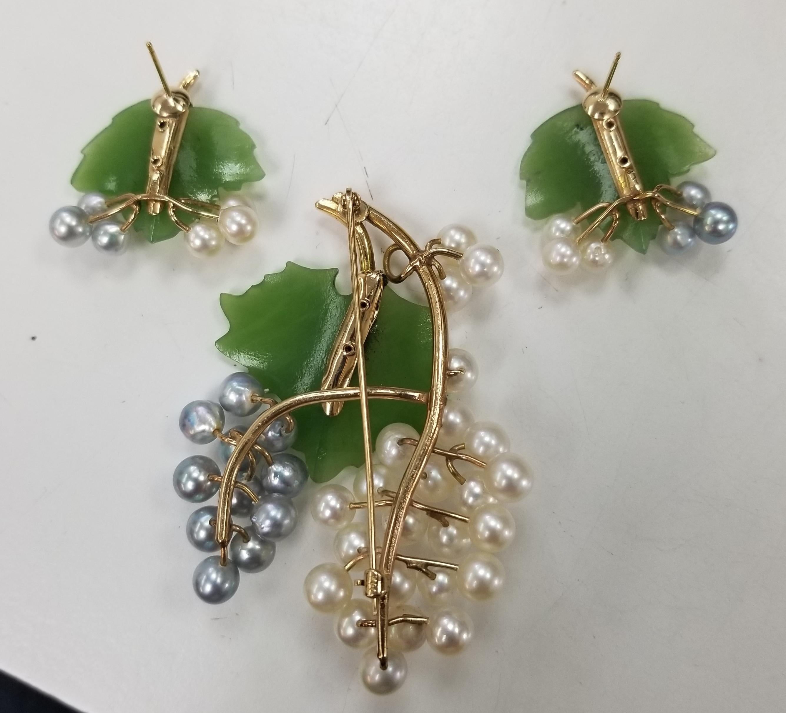 This gorgeous, Mid Century vintage brooch,  features carved nephrite and pearls in a 14 karat gold floral motif. 
There are two (2) carved nephrite jade leaves, each carved by hand and 37 pearls measuring 5-6mm(the piece is old enough that the