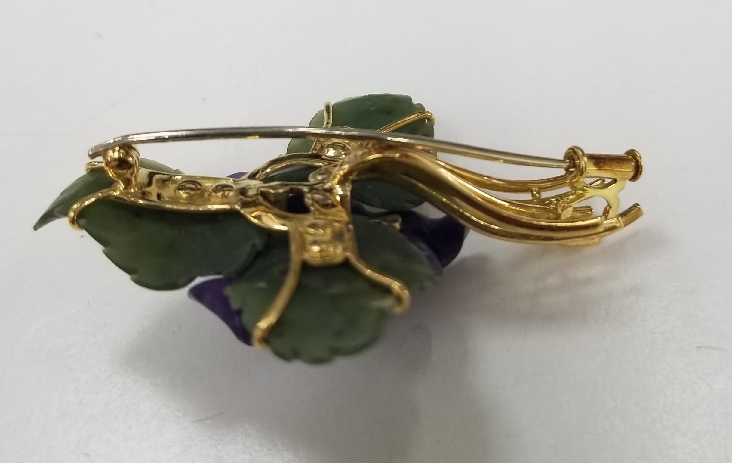 This gorgeous set of 3, Mid Century vintage brooch,  features carved amethyst and nephrite set in a 14 karat gold floral motif. with 4 round diamonds .06pts.
There are two (2) carved amethyst flowers and two (2) carved nephrite jade leaves, each
