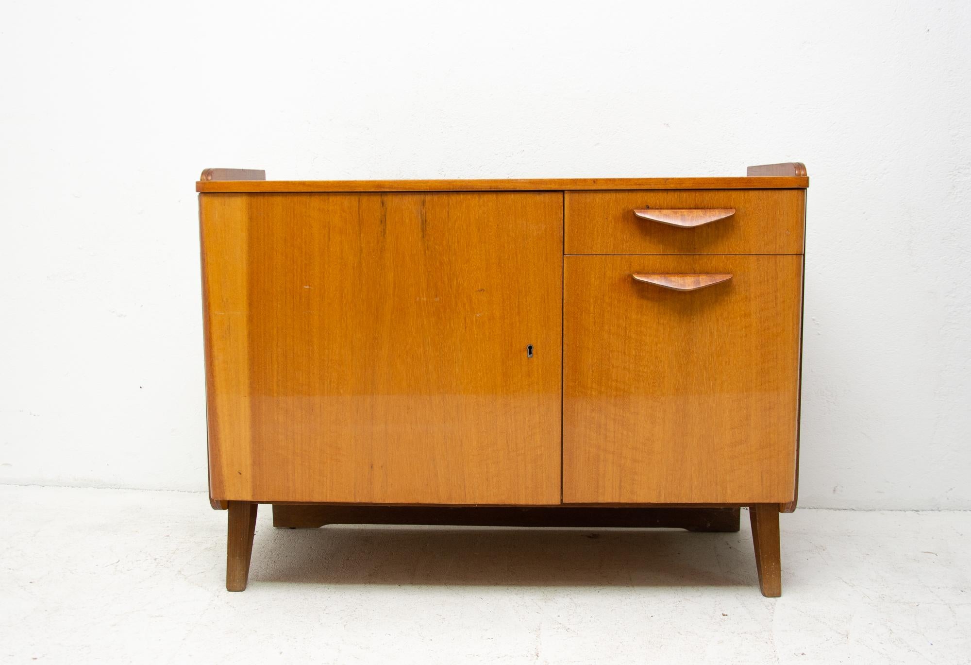 Midcentury vintage small cabinet or TV table from the 1960s. It was designed by František Jirák and was manufactured by Tatra Nábytok Company in the former Czechoslovakia. In very good condition. Beautiful walnut veneer, plywood.