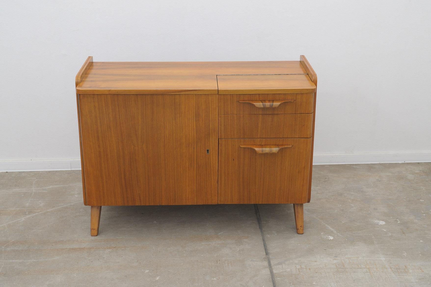 Mid century Vintage small cabinet or TV table from the 1960´s. It was designed by František Jirák and was manufactured by Tatra nábytok company in the former Czechoslovakia. Walnut veneer, plywood. In very good condition with slight signs of age and
