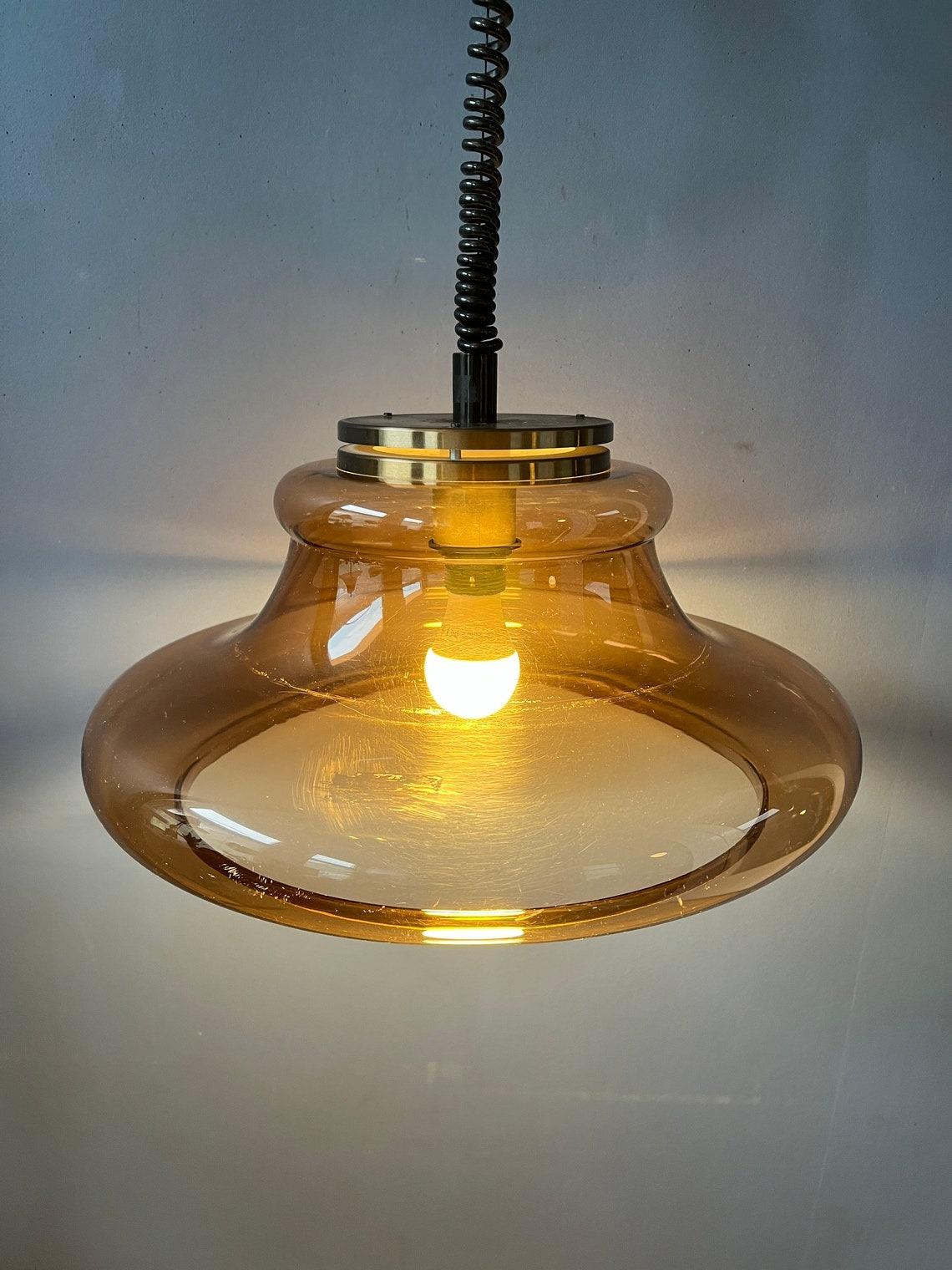 A space age pendant lamp by Herda with transparent shade. The shade consists of acrylic glass in a copper-like colour. The height of the lamp can be adjusted with the rise-and-fall system.

Additional information:
Materials: Metal, plastic
Period: