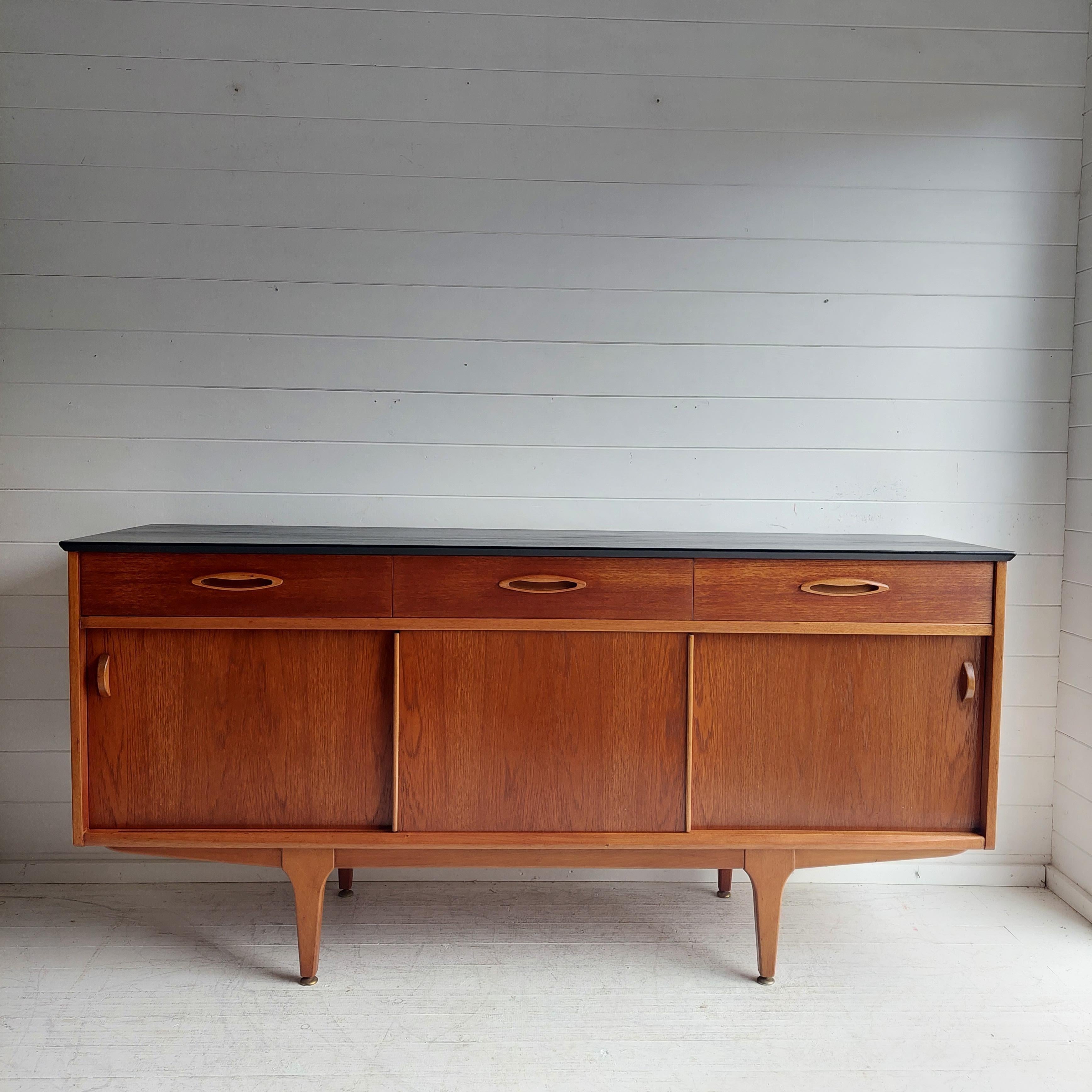 Restored 167.5cm sliding door unit for Jentique.

Rare model, teak enfilade edited by Jentique in the 1960s. 
It has three sliding doors and three drawers. 
The sliding doors reveal on the sides compartments an internal fix shelf.
The drawers have