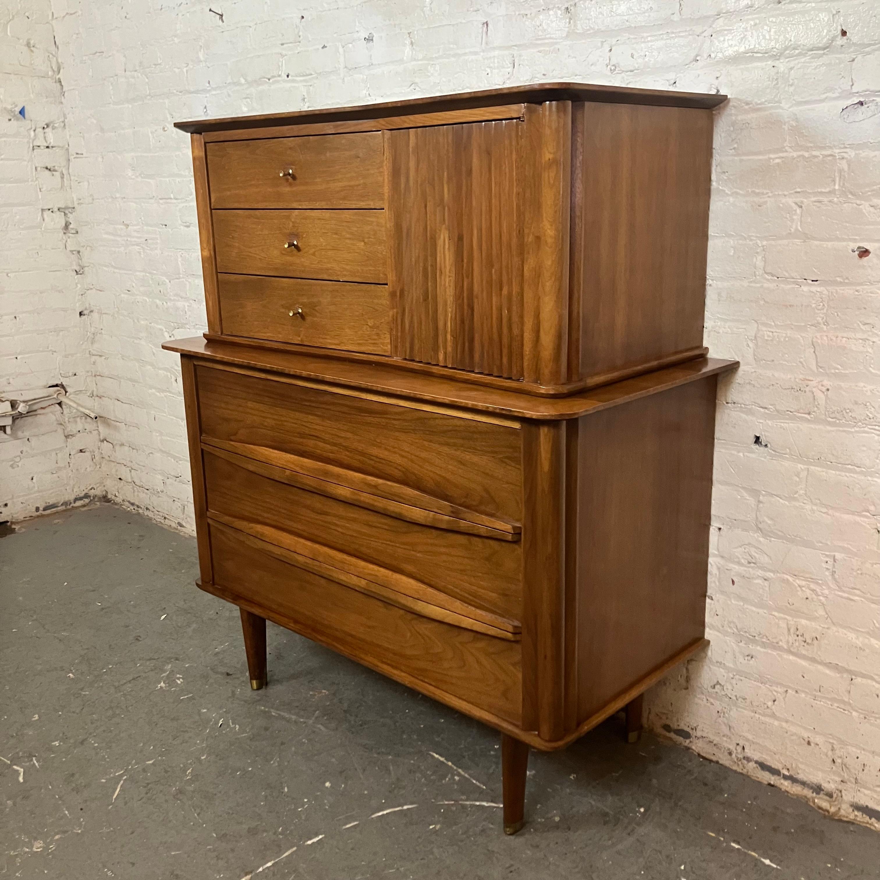 Add some funky '50s flair into any space with this mid-century vintage boomerang gentleman's chest from the master craftsmen of Lexington, North Carolina's United Furniture Corporation! This robust case piece features a groovy asymmetrical top, a