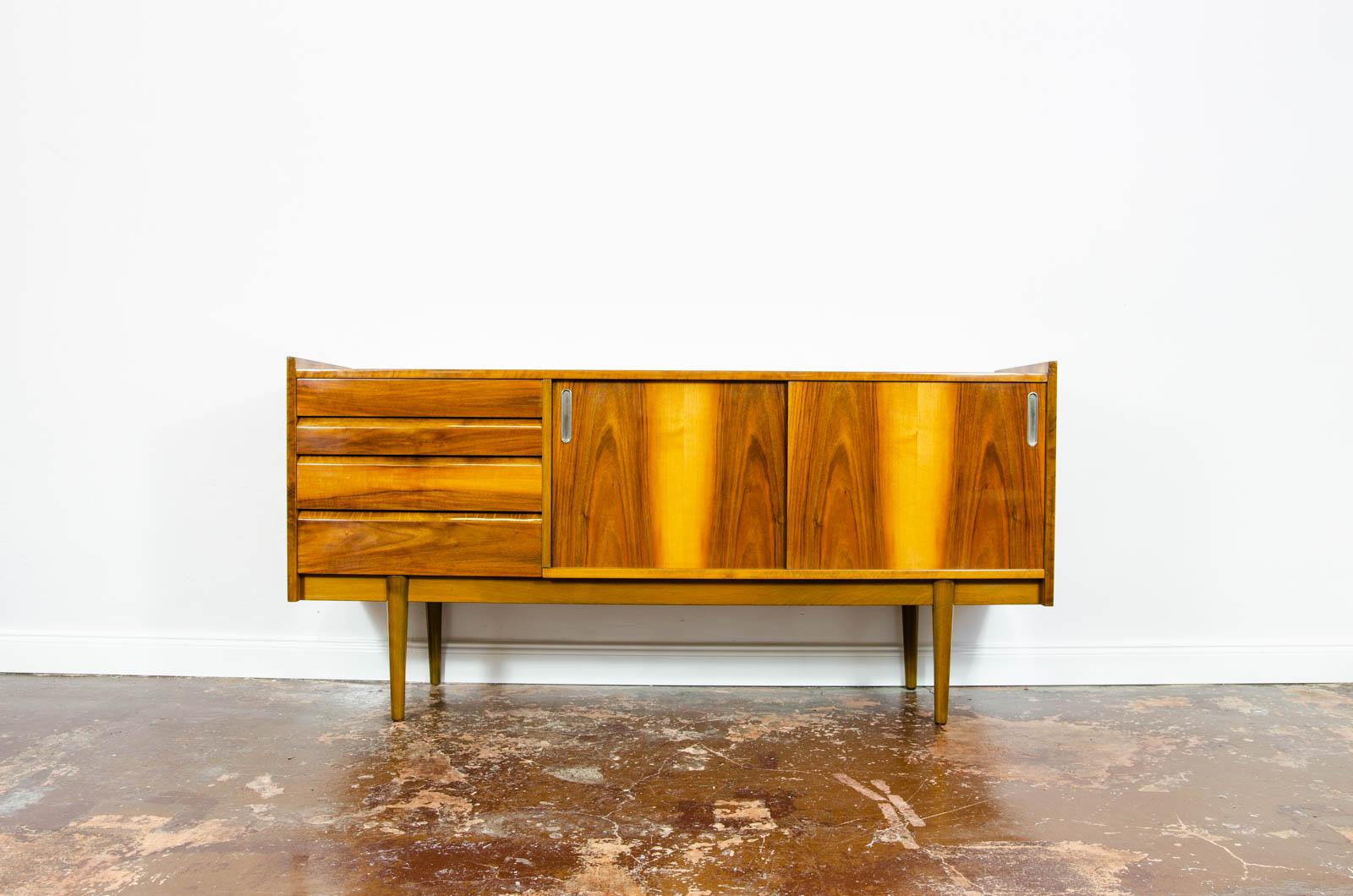 Mid-century vintage walnut high-gloss sideboard from Bytomskie Furniture Factory, Poland, 1960s.
Sideboard is walnut veneered, finished in original high gloss finish.
Credenza has four drawers, sliding doors with metal handles and two internal