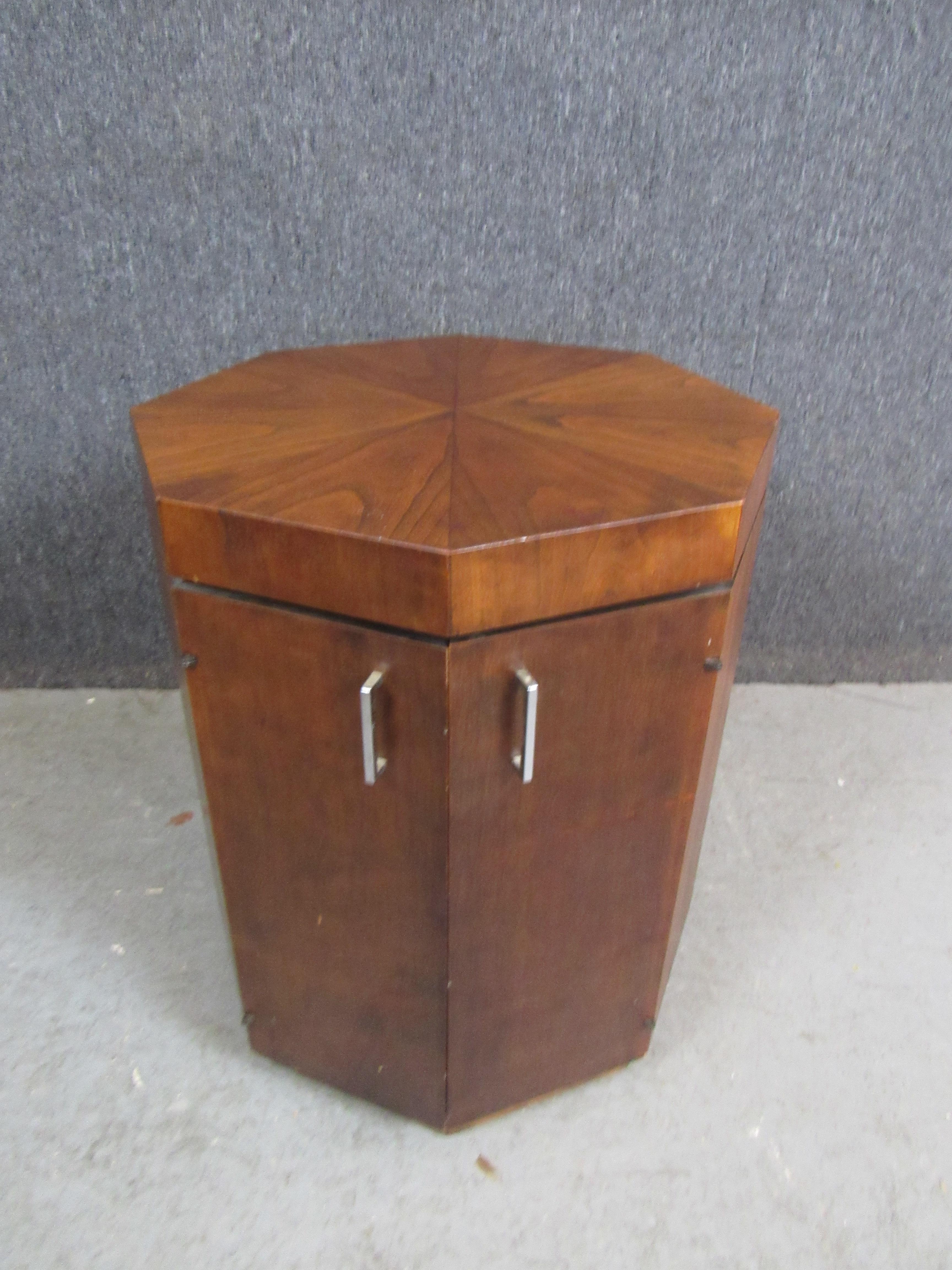 Make your home decor stand out from the crowd with this beautiful octagonal side table/cabinet. It's unique shape lends to it's spellbinding kaleidoscopic walnut veneered top, resulting in a practical piece that will create an impression for many