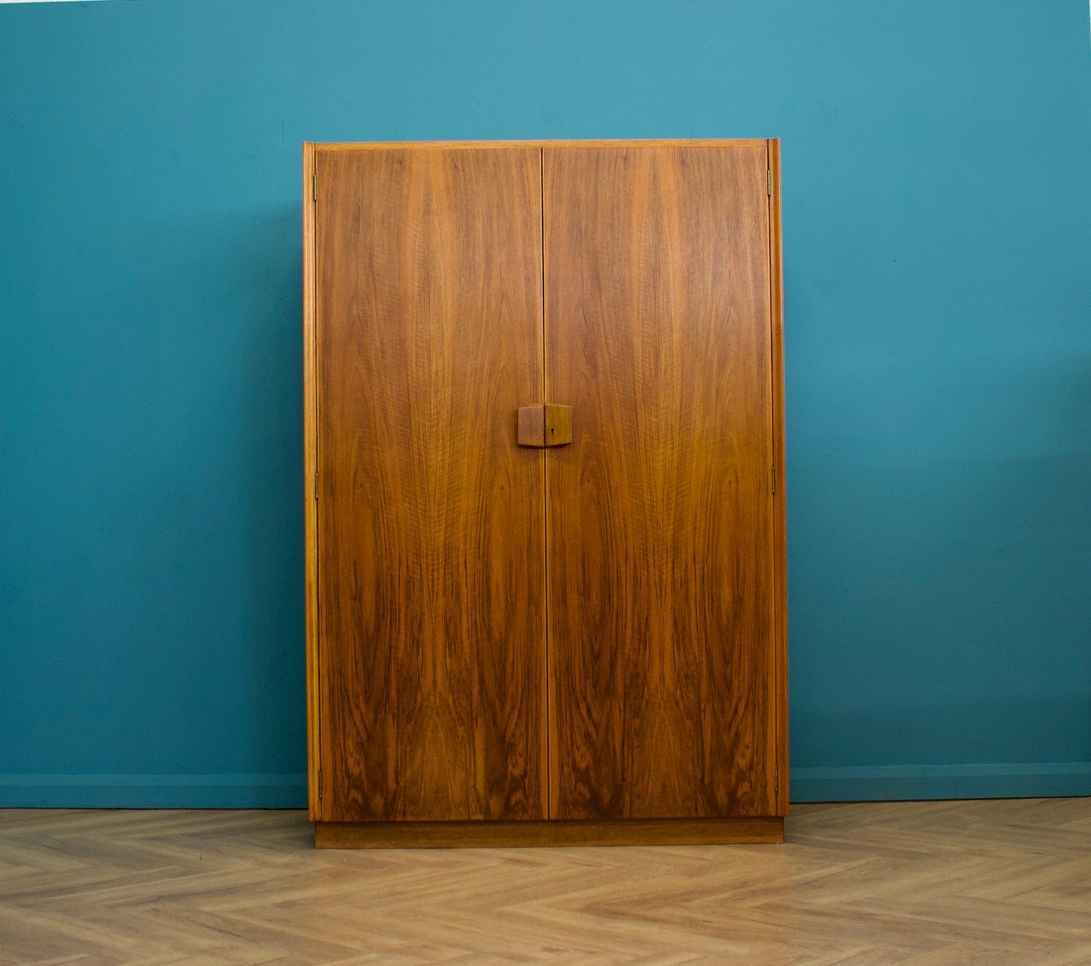 A walnut freestanding wardrobe by Gordon Russell - circa 1950s
Internally there are two rails and a shelf

The matching wardrobe is listed separately 