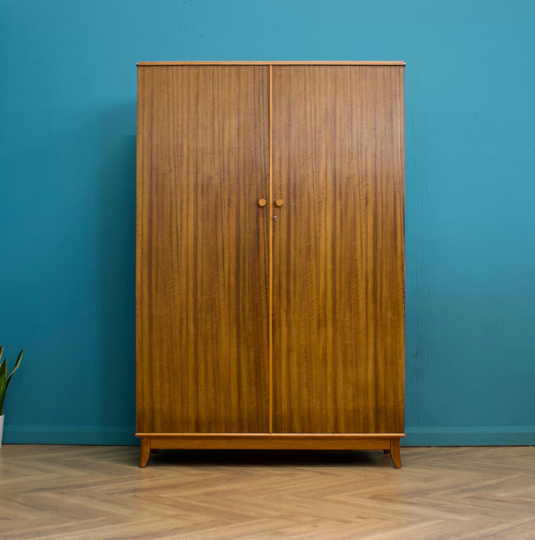 A walnut freestanding wardrobe by Heals - circa 1950s
Internally there are two rails and a shelf
The attractive legs are slightly tapered and splayed, complete with a working lock 

The matching dressing table is available on a separate listing 