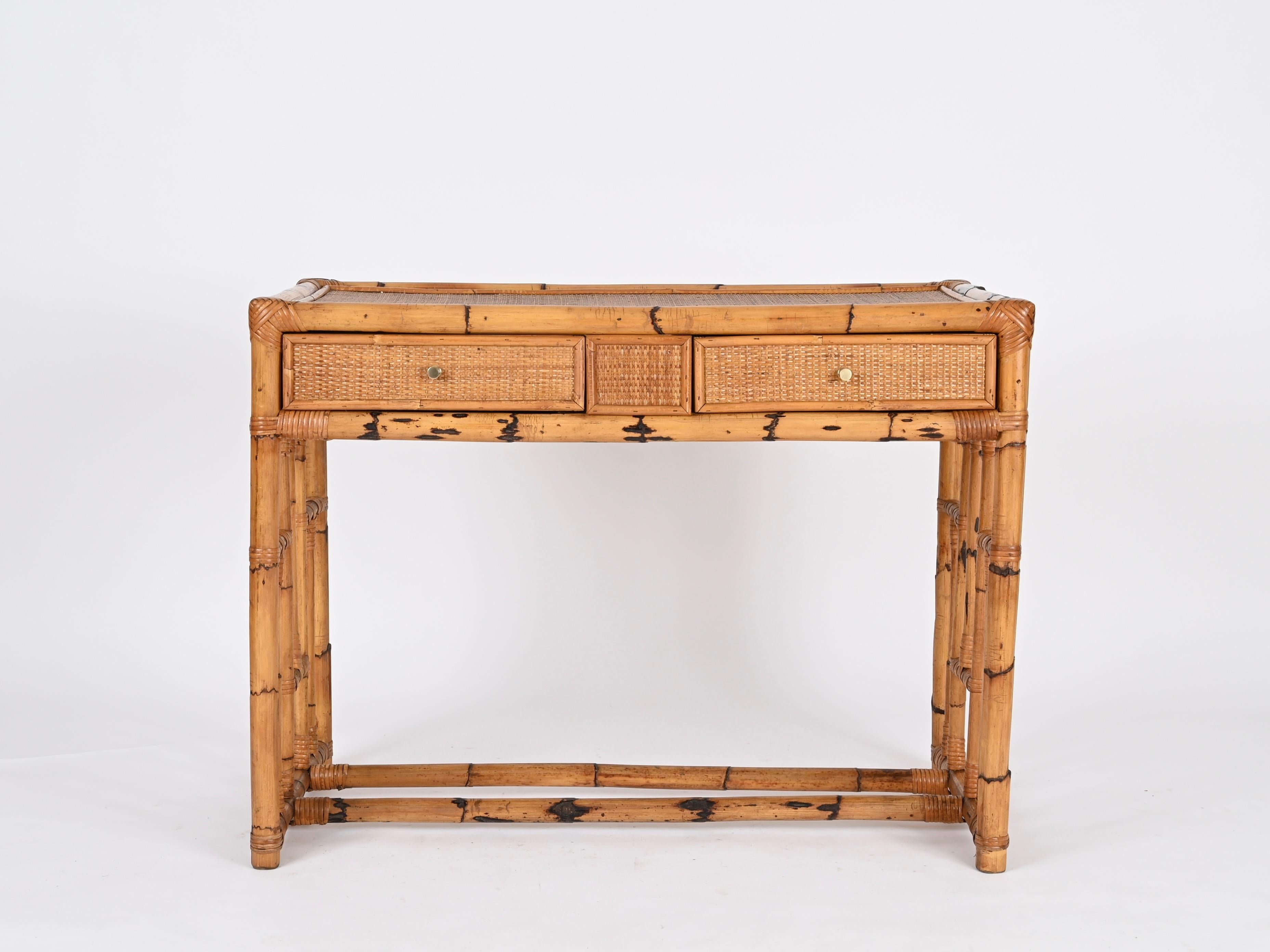Stunning mid-century organic desk with drawers fully made in a gorgeous combination of bamboo, rattan, hand-woven wicker and brass. This stylish desk was produced by Vivai del Sud in Italy during the 1970s.

The desk is in amazing condition and has