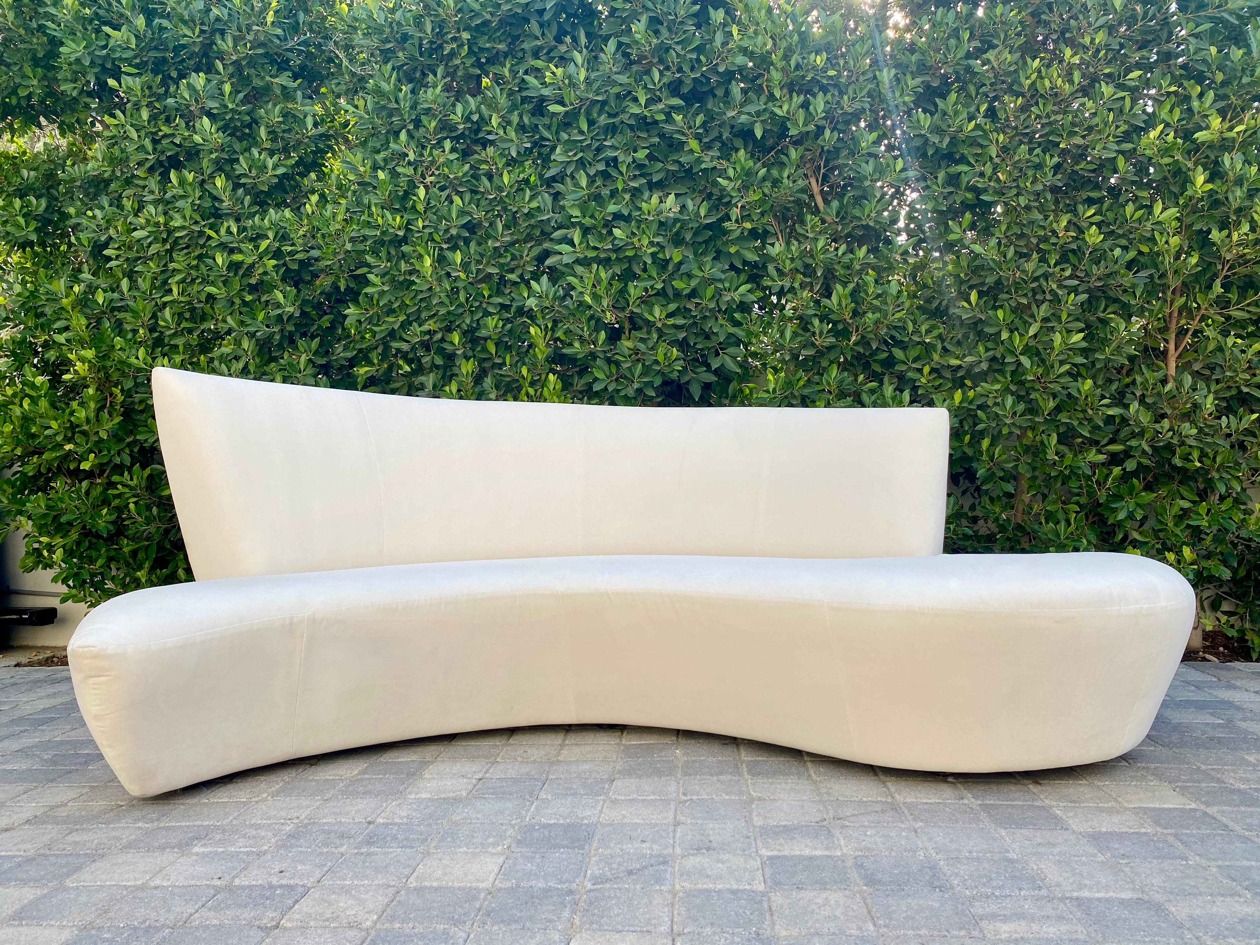 A sculptural modern sofa designed by Vladimir Kagan and inspired by the curves and undulations of the Guggenheim Museum in Bilbao Spain. Recently reupholstered in high quality ivory velvet.