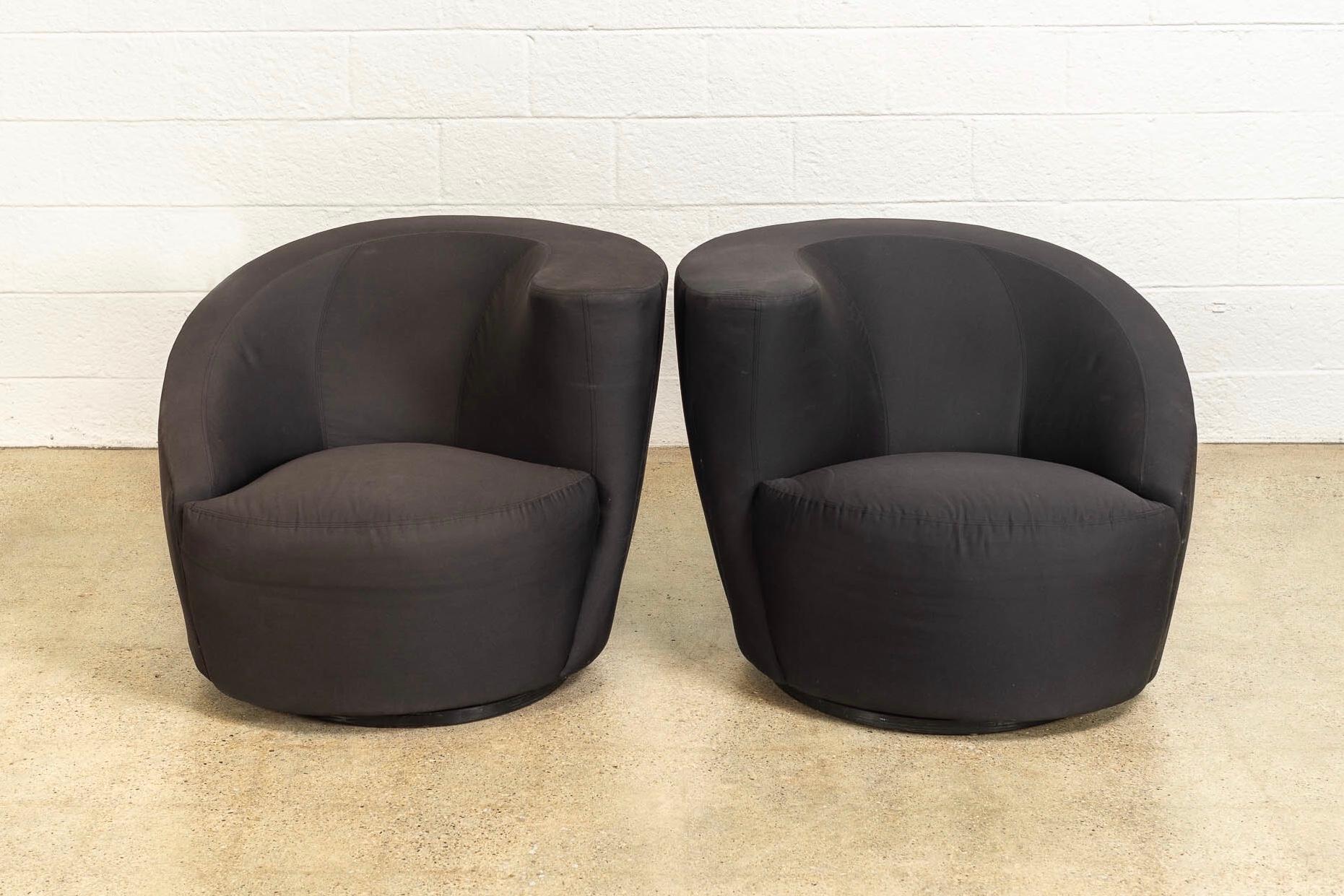 This pair of vintage Mid-Century Modern “Nautilus” club chairs designed by Vladimir Kagan for Directional are circa 1970. The iconic design features classic Kagan style with distinctive curves and elegant organic lines. Upholstered in a black cotton