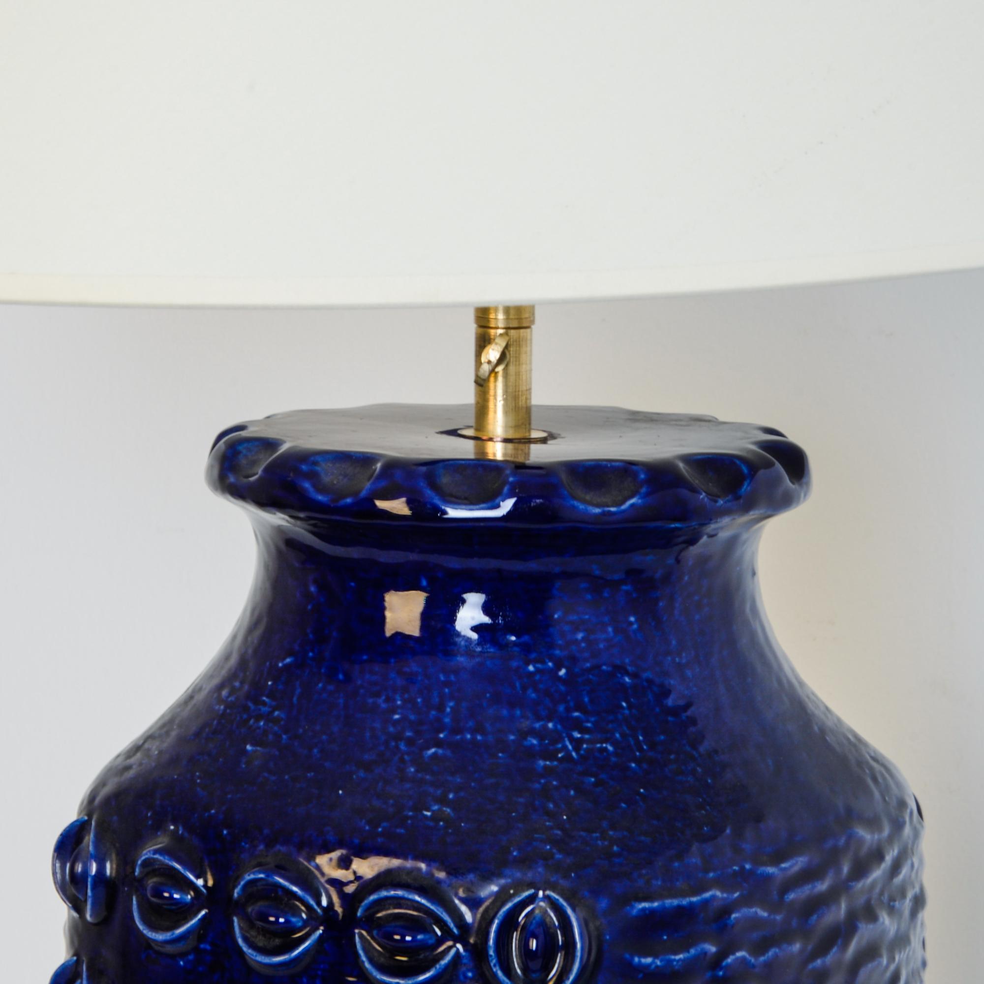A patterned dark blue vase has been fitted with modern brass adjustable fixture and E26 lighting socket. These brilliant midcentury ceramic vases were produced primarily in the 1970s, marked with 