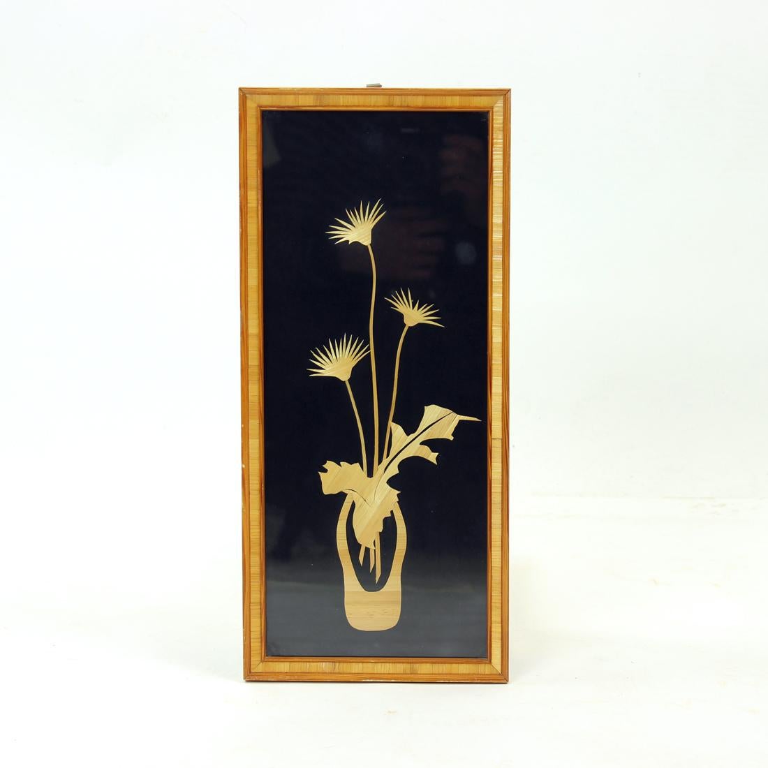 Beautiful wall art piece for Czechoslovakia in 1960s. The art piece was created in Czechoslovakia and shows a typical style of the era. The original wooden frame holds black background on which flowers are made out of straw. The art is under a glass