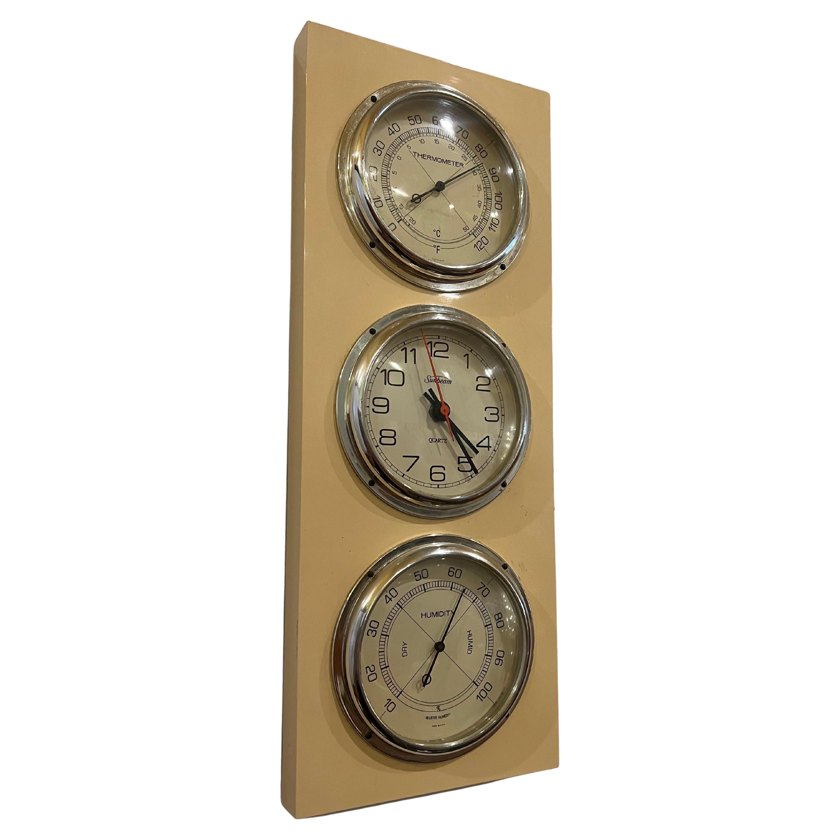 A classic space age clock weather station by Sumbeam thermometer , clock and barometer cream color plastic case with chome rings.