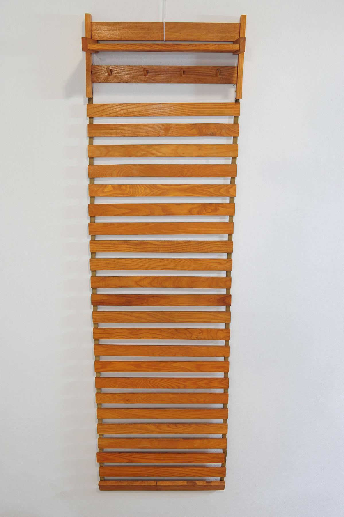 Czechoslovak mid-century folding wall hanger was made by ULUV company in the former Czechoslovakia in the 1960s.  It´s made of beech wood. It´s in good original condition, showing signs of age and using.
Folding slats follow the upper hanger and