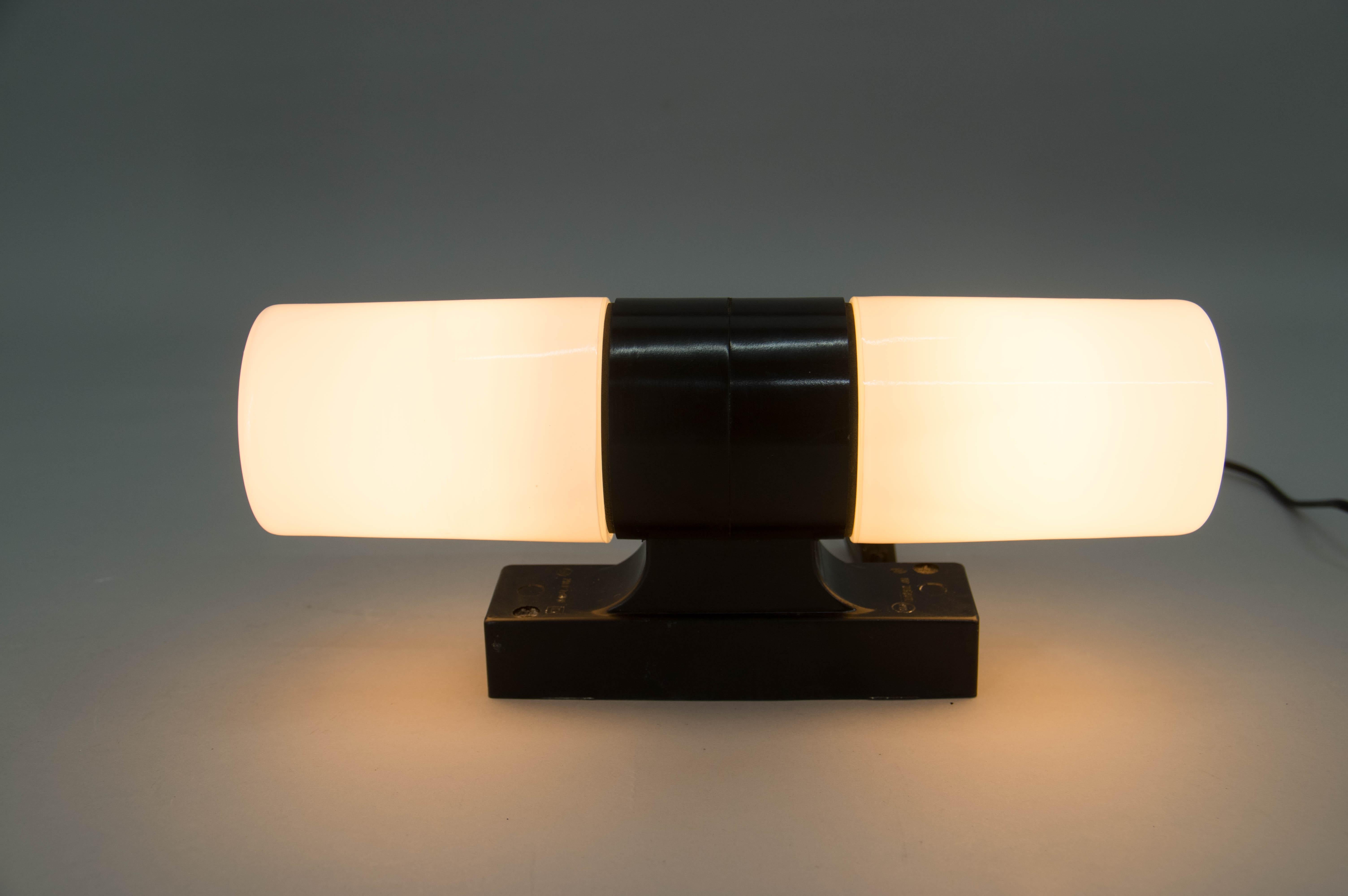 Designed in the 1950s in former Czechoslovakia as bathroom light above a mirror. Bakelite holders and opal glass shades. Seal rubber against moisture. Bulbs E14-E15, 2x40W US compatible cable.