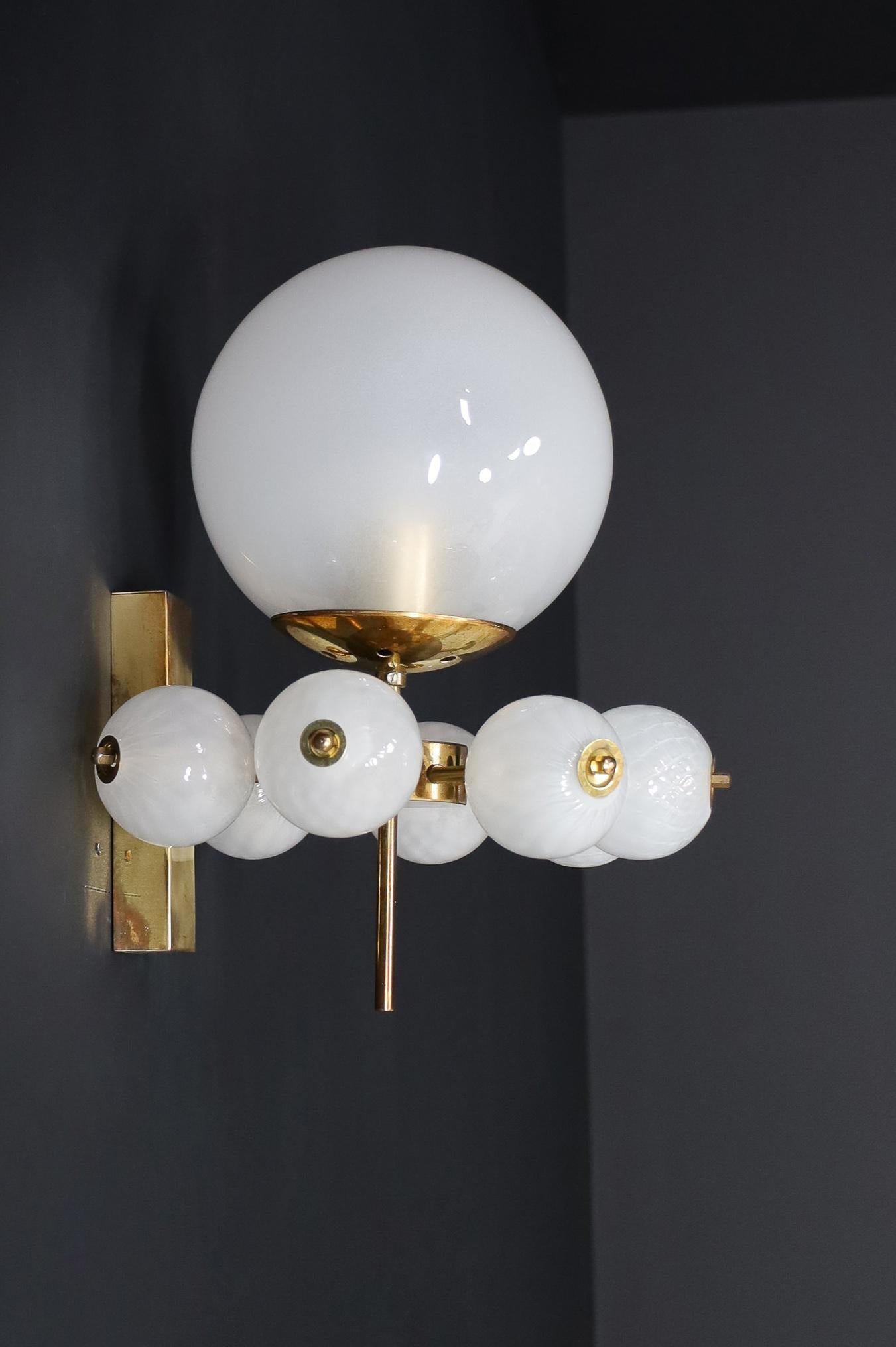 Mid-Century Wall Lights with Brass Fixture and Hand-Blown Pearl-White Glass Globes by Preciosa, Czechia, 1960

This stunning Mid-Century wall light features a brass fixture designed and produced by the renowned Preciosa Factory in Czechia. It