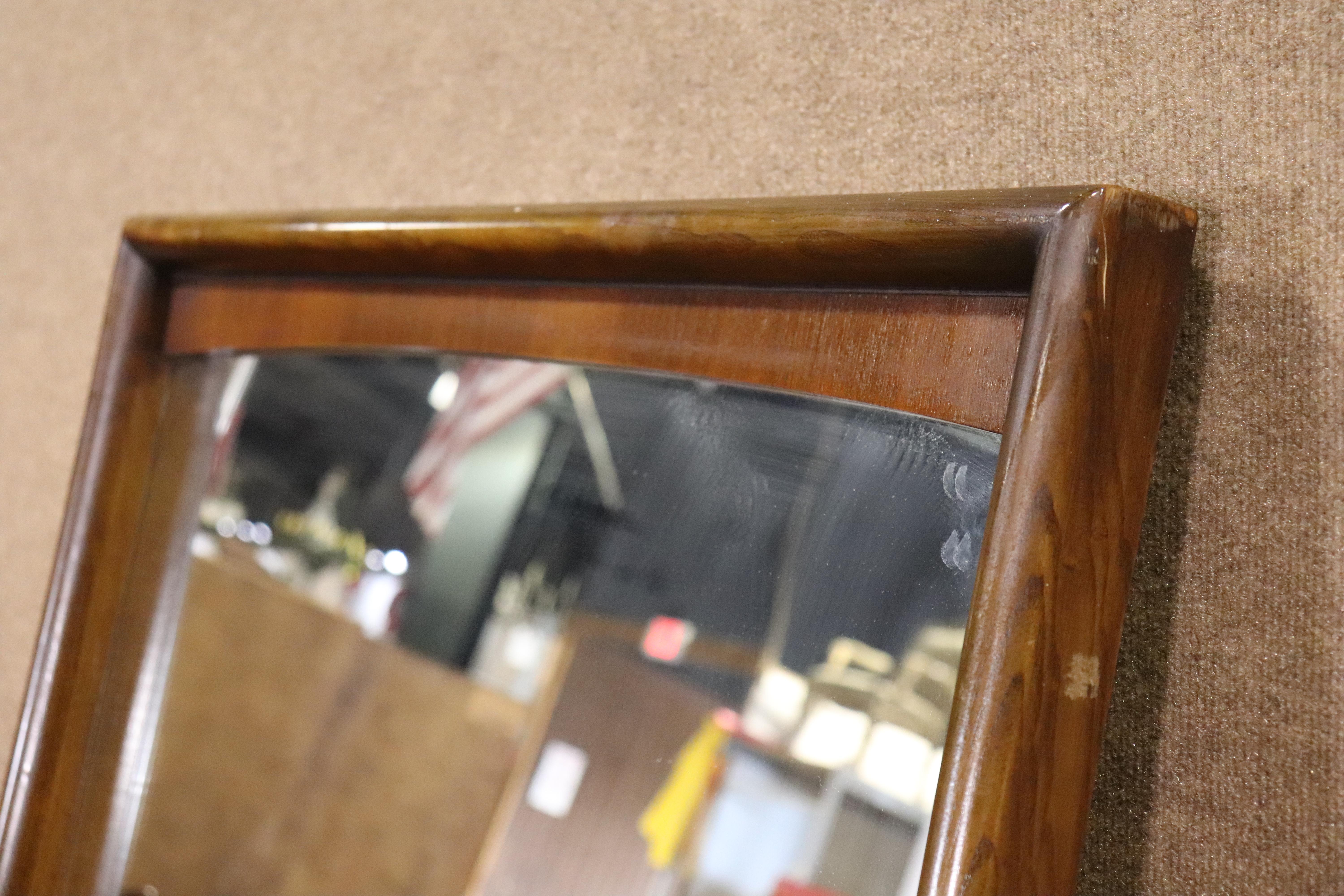 Mid-century modern walnut wall mirror by United Furniture. Simple sculpted trim in warm walnut grain. Can be adjusted to hang vertical or horizontally.
Please confirm location NY or NJ