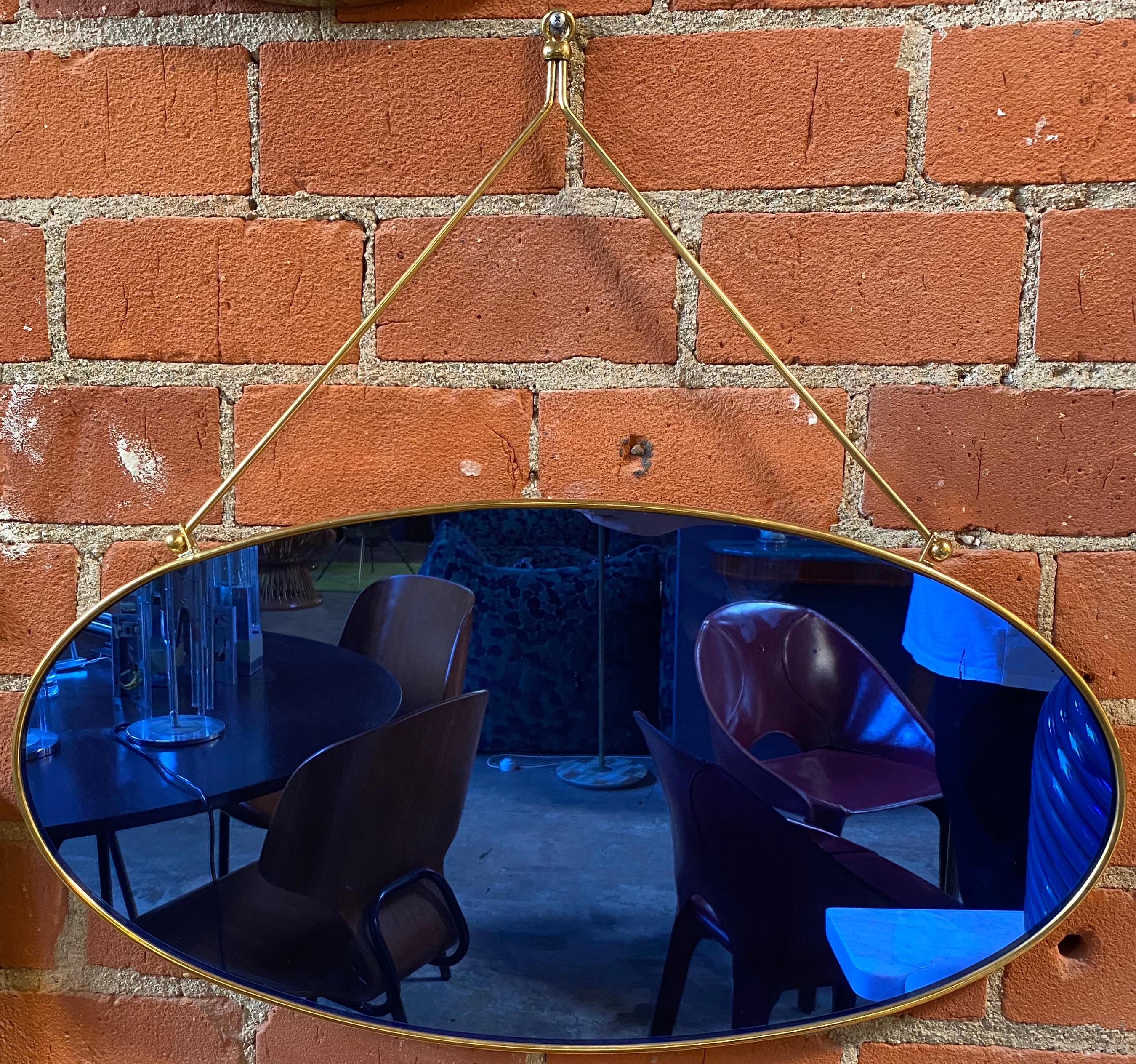 Stunning Italian mirror from 70s in a beautiful shape with a blue glass.